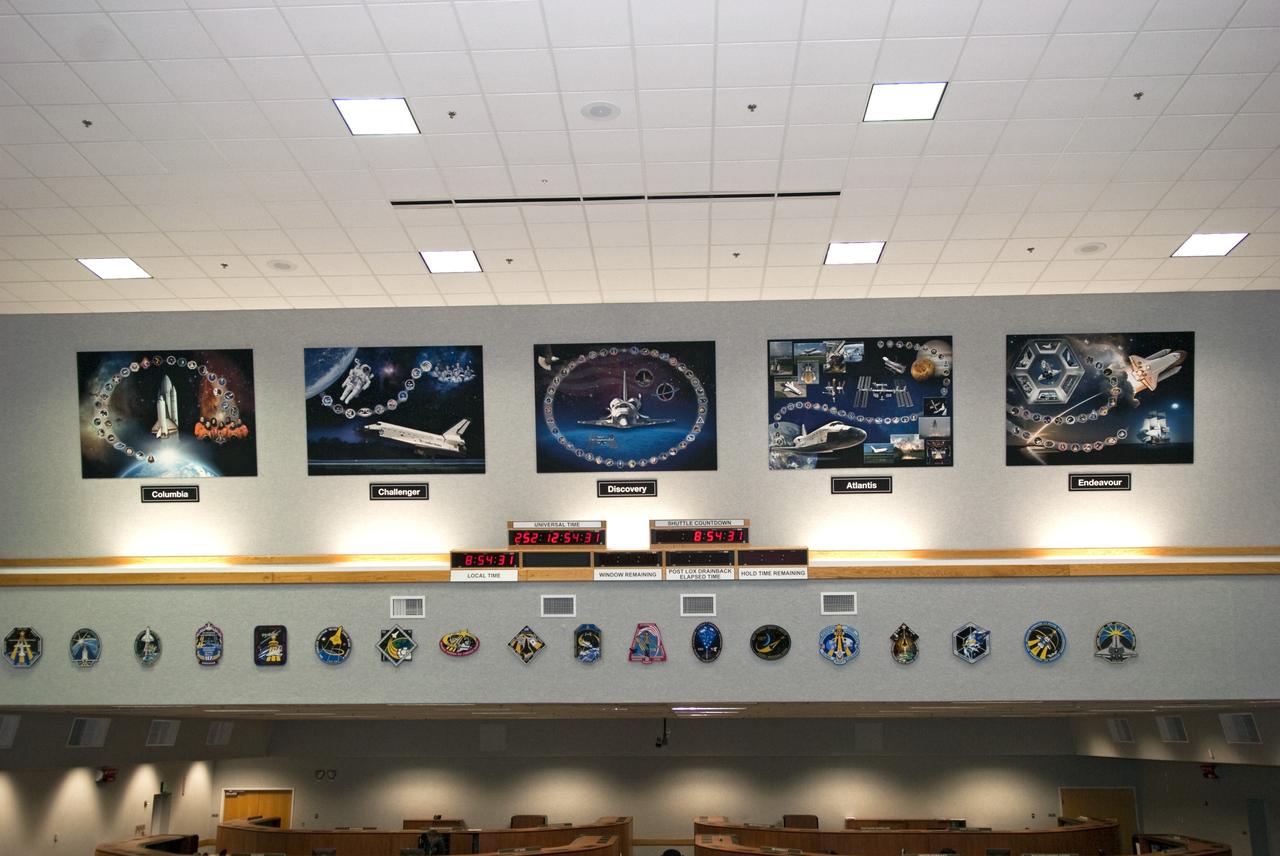 CAPE CANAVERAL, Fla. -- At NASA's Kennedy Space Center in Florida, five orbiter tributes are on display in Firing Room 4 of the Launch Control Center. Above the space shuttle countdown clock, from left and the order in which they have flown, are Columbia, Challenger, Discovery, Atlantis and Endeavour. The tributes feature major accomplishments and significant achievements made by each shuttle, as well as mission patches and processing milestones.    Photo credit: NASA/Jim Grossmann