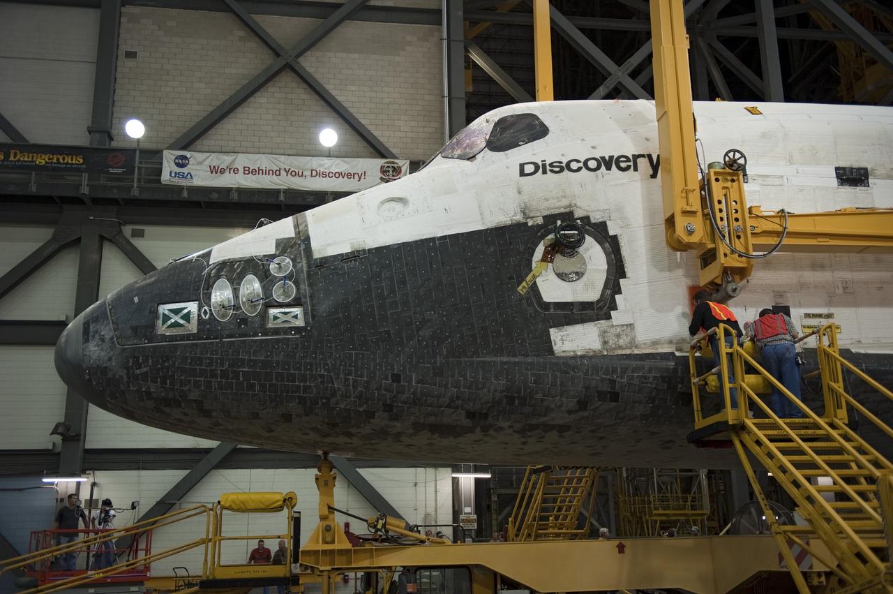 CAPE CANAVERAL, Fla. -- At NASA's Kennedy Space Center in Florida, workers in the Vehicle Assembly Building secure a large yellow, metal sling to shuttle Discovery for its lift from the transfer aisle into High Bay 3. In the bay, the shuttle will be attached to its external fuel tank and solid rocket boosters. The operation began Sept. 9 and wrapped up early Sept. 10. Discovery is scheduled to roll out to Launch Pad 39A later this month in preparation for its launch to the International Space Station on the STS-133 mission. Targeted to lift off Nov. 1, Discovery will take the Permanent Multipurpose Module (PMM) packed with supplies and critical spare parts, as well as Robonaut 2 (R2) to the station. Photo credit: NASA/Kim Shiflett