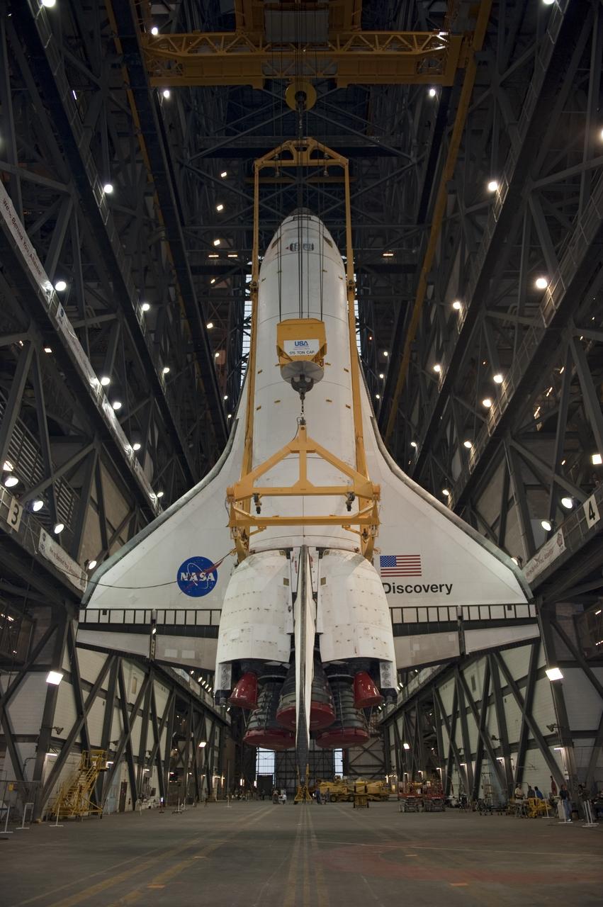 CAPE CANAVERAL, Fla. -- At NASA's Kennedy Space Center in Florida, a large yellow, metal sling lifts shuttle Discovery from the transfer aisle into High Bay 3 of the Vehicle Assembly Building. In the bay, the shuttle will be attached to its external fuel tank and solid rocket boosters. The operation began Sept. 9 and wrapped up early Sept. 10. Discovery is scheduled to roll out to Launch Pad 39A later this month in preparation for its launch to the International Space Station on the STS-133 mission. Targeted to lift off Nov. 1, Discovery will take the Permanent Multipurpose Module (PMM) packed with supplies and critical spare parts, as well as Robonaut 2 (R2) to the station. Photo credit: NASA/Kim Shiflett