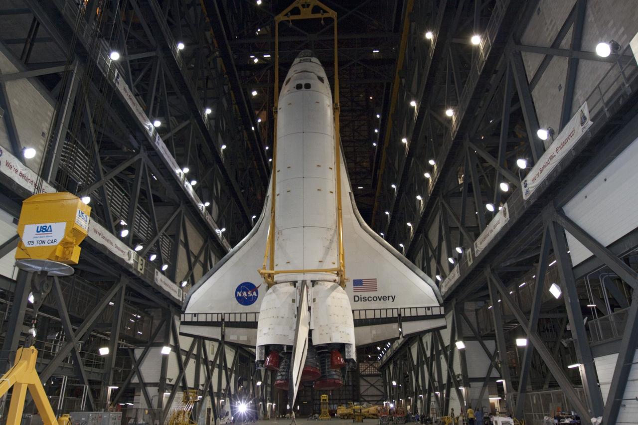 CAPE CANAVERAL, Fla. -- At NASA's Kennedy Space Center in Florida, a large yellow, metal sling lifts shuttle Discovery from the transfer aisle into High Bay 3 of the Vehicle Assembly Building. In the bay, the shuttle will be attached to its external fuel tank and solid rocket boosters. The operation began Sept. 9 and wrapped up early Sept. 10. Discovery is scheduled to roll out to Launch Pad 39A later this month in preparation for its launch to the International Space Station on the STS-133 mission. Targeted to lift off Nov. 1, Discovery will take the Permanent Multipurpose Module (PMM) packed with supplies and critical spare parts, as well as Robonaut 2 (R2) to the station. Photo credit: NASA/Jack Pfaller