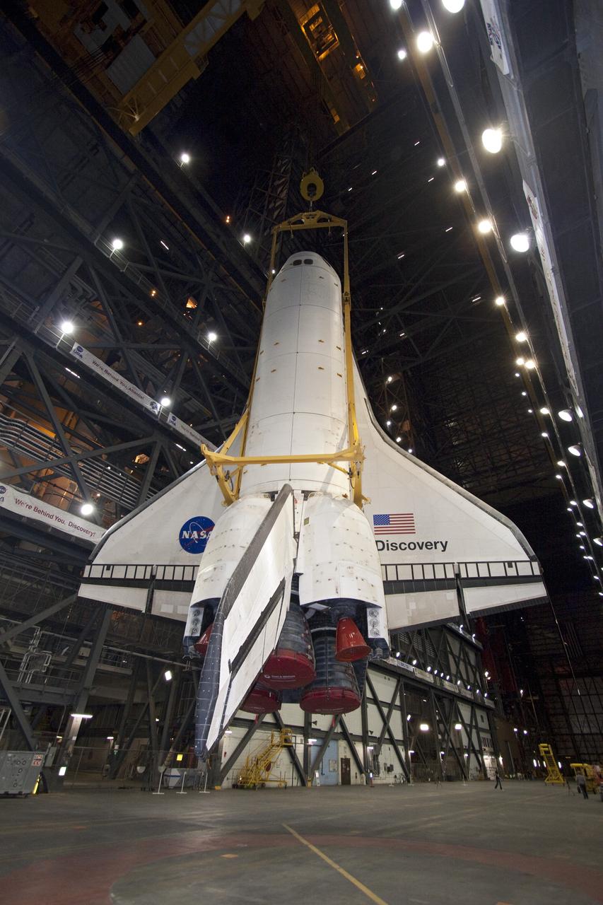 CAPE CANAVERAL, Fla. -- At NASA's Kennedy Space Center in Florida, a large yellow, metal sling lifts shuttle Discovery from the transfer aisle into High Bay 3 of the Vehicle Assembly Building. In the bay, the shuttle will be attached to its external fuel tank and solid rocket boosters. The operation began Sept. 9 and wrapped up early Sept. 10. Discovery is scheduled to roll out to Launch Pad 39A later this month in preparation for its launch to the International Space Station on the STS-133 mission. Targeted to lift off Nov. 1, Discovery will take the Permanent Multipurpose Module (PMM) packed with supplies and critical spare parts, as well as Robonaut 2 (R2) to the station. Photo credit: NASA/Jack Pfaller