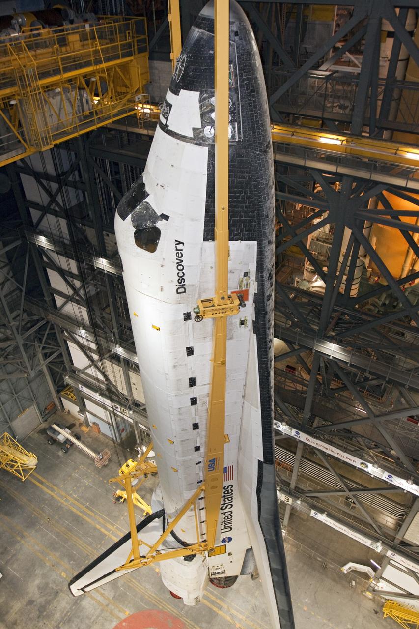 CAPE CANAVERAL, Fla. -- At NASA's Kennedy Space Center in Florida, a large yellow, metal sling lifts shuttle Discovery from the transfer aisle into High Bay 3 of the Vehicle Assembly Building. In the bay, the shuttle will be attached to its external fuel tank and solid rocket boosters. The operation began Sept. 9 and wrapped up early Sept. 10. Discovery is scheduled to roll out to Launch Pad 39A later this month in preparation for its launch to the International Space Station on the STS-133 mission. Targeted to lift off Nov. 1, Discovery will take the Permanent Multipurpose Module (PMM) packed with supplies and critical spare parts, as well as Robonaut 2 (R2) to the station. Photo credit: NASA/Jack Pfaller