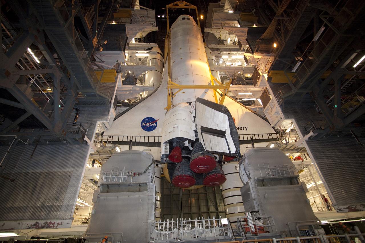 CAPE CANAVERAL, Fla. -- In High Bay 3 of the Vehicle Assembly Building at NASA's Kennedy Space Center in Florida, a large yellow, metal sling lowers shuttle Discovery to its external fuel tank and solid rocket boosters. The lift and mate operation began Sept. 9 and wrapped up early Sept. 10. Discovery is scheduled to roll out to Launch Pad 39A later this month in preparation for its launch to the International Space Station on the STS-133 mission. Targeted to lift off Nov. 1, Discovery will take the Permanent Multipurpose Module (PMM) packed with supplies and critical spare parts, as well as Robonaut 2 (R2) to the station. Photo credit: NASA/Jack Pfaller