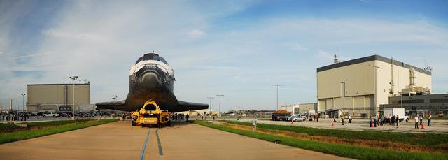 CAPE CANAVERAL, Fla. -- This panoramic image of space shuttle Discovery was photographed as it was being transported from Orbiter Processing Facility-3 at NASA's Kennedy Space Center in Florida, to the Vehicle Assembly Building escorted by workers.            Once inside the VAB, the shuttle will be joined to its solid rocket boosters and external fuel tank. Later this month, Discovery is scheduled to "rollout" to Launch Pad 39A for its launch to the International Space Station on the STS-133 mission. Targeted to liftoff Nov. 1, Discovery will take the Permanent Multipurpose Module (PMM) packed with supplies and critical spare parts, as well as Robonaut 2 (R2) to the station. Photo credit: NASA/Frankie Martin