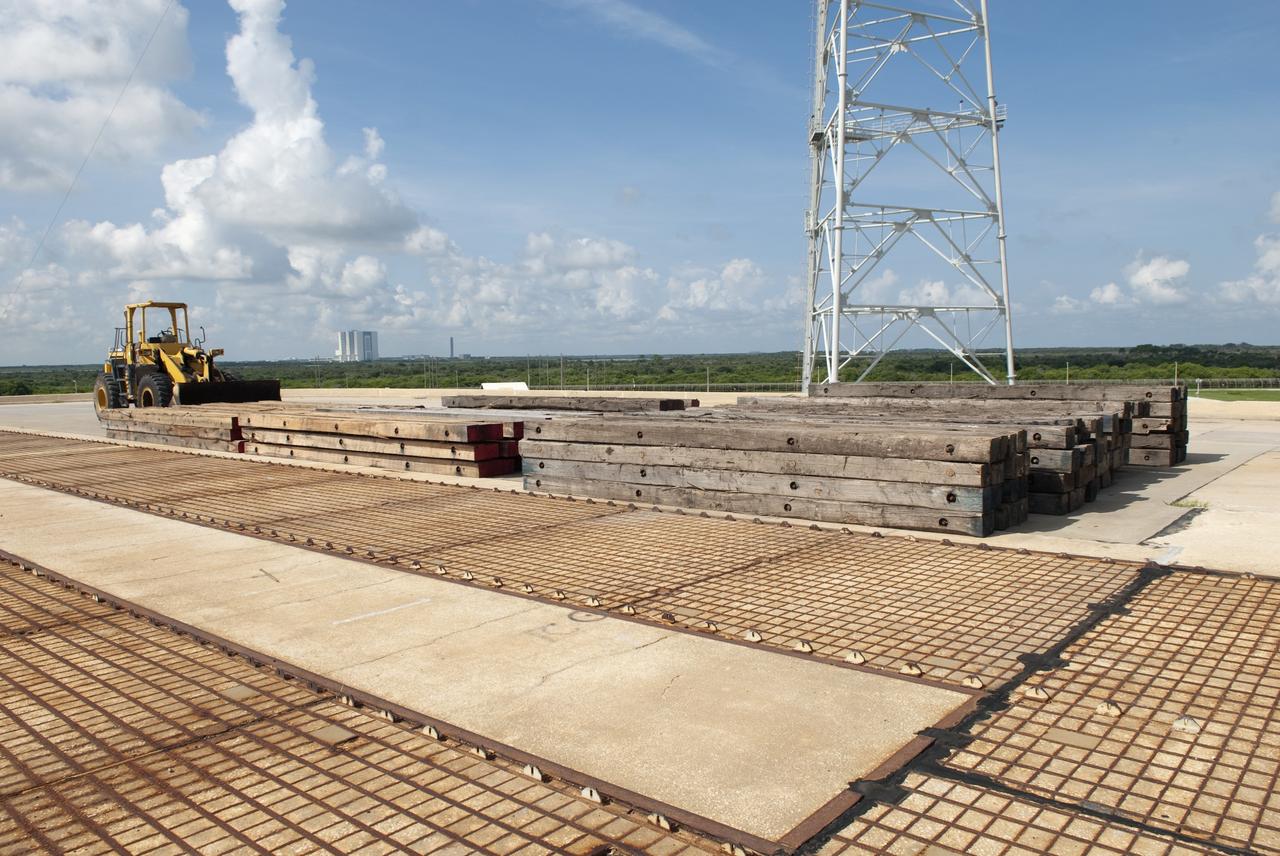 CAPE CANAVERAL, Fla. -- At NASA's Kennedy Space Center in Florida, construction crews lay sand, reinforcing steel and large wooden mats under the rotating service structure (RSS) of Launch Pad 39B to protect the structure's concrete from falling debris during deconstruction.     Starting in 2009, the structure at the pad was no longer needed for NASA's Space Shuttle Program, so it is being restructured for future use. The new design will feature a "clean pad" for rockets to come with their own launcher, making it more versatile for a number of vehicles. For information on NASA's future plans, visit www.nasa.gov. Photo credit: NASA/Jim Grossmann