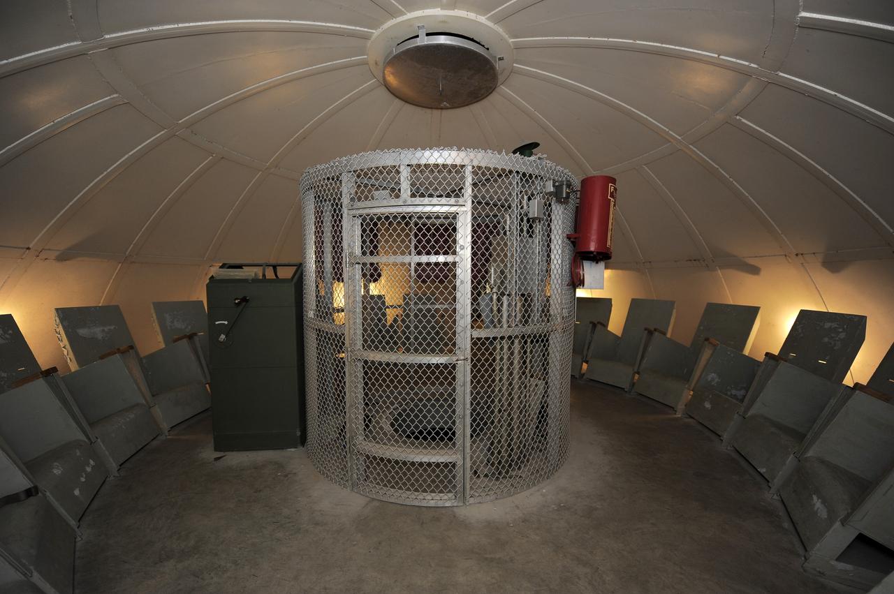 CAPE CANAVERAL, Fla. -- Empty fire blanket holders and 20 contour chairs remain in the blast-resistant "rubber room" beneath Launch Pad 39B at NASA's Kennedy Space Center in Florida. The room is a steel dome floating on rubber isolators and was used as an escape route during the Apollo Program in case of an emergency. It has since been abandoned by astronauts, but throughout the years nature found its way inside, including raccoons, snakes, birds and even a bobcat and opossum.    Starting in 2009, the structure above the room on the pad was no longer needed for NASA's Space Shuttle Program, so it is being restructured for future use. The new design will feature a "clean pad" for rockets to come with their own launcher, making it more versatile for a number of vehicles. For information on NASA's future plans, visit www.nasa.gov. Photo credit: NASA/Kim Shiflett