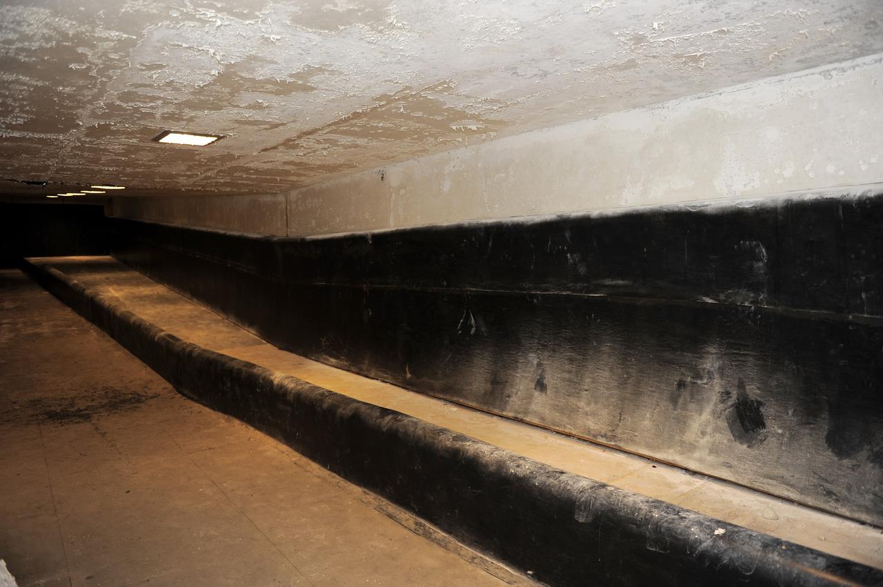 CAPE CANAVERAL, Fla. -- A tunnel beneath Launch Pad 39B at NASA's Kennedy Space Center in Florida leads to the blast-resistant "rubber room." The room is a steel dome floating on rubber isolators and was used as an escape route during the Apollo Program in case of an emergency. It has since been abandoned by astronauts, but throughout the years nature found its way inside, including raccoons, snakes, birds and even a bobcat and opossum.    Starting in 2009, the structure above the room on the pad was no longer needed for NASA's Space Shuttle Program, so it is being restructured for future use. The new design will feature a "clean pad" for rockets to come with their own launcher, making it more versatile for a number of vehicles. For information on NASA's future plans, visit www.nasa.gov. Photo credit: NASA/Kim Shiflett