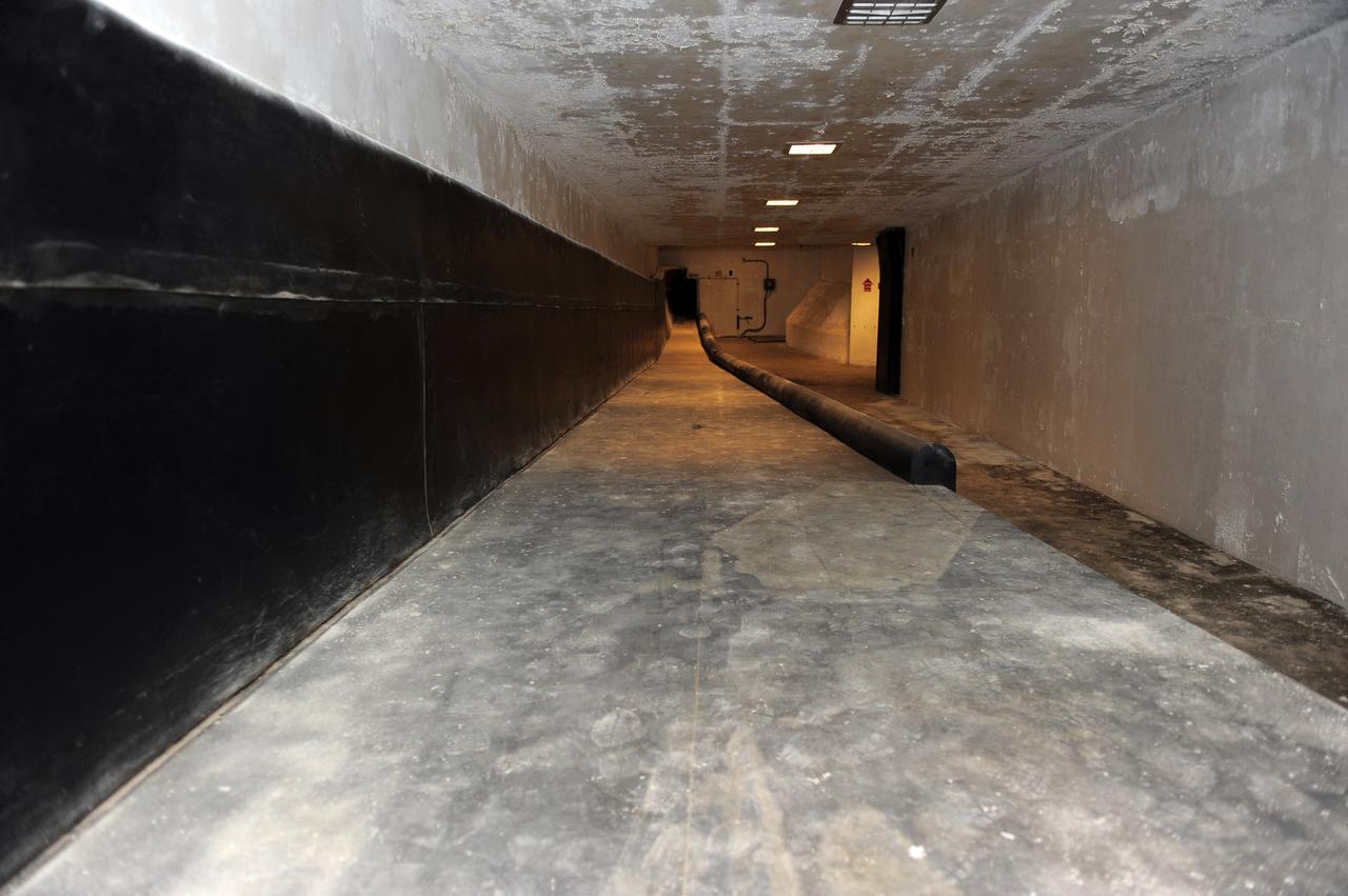 CAPE CANAVERAL, Fla. -- A tunnel beneath Launch Pad 39B at NASA's Kennedy Space Center in Florida leads to the blast-resistant "rubber room." The room is a steel dome floating on rubber isolators and was used as an escape route during the Apollo Program in case of an emergency. It has since been abandoned by astronauts, but throughout the years nature found its way inside, including raccoons, snakes, birds and even a bobcat and opossum.    Starting in 2009, the structure above the room on the pad was no longer needed for NASA's Space Shuttle Program, so it is being restructured for future use. The new design will feature a "clean pad" for rockets to come with their own launcher, making it more versatile for a number of vehicles. For information on NASA's future plans, visit www.nasa.gov. Photo credit: NASA/Kim Shiflett
