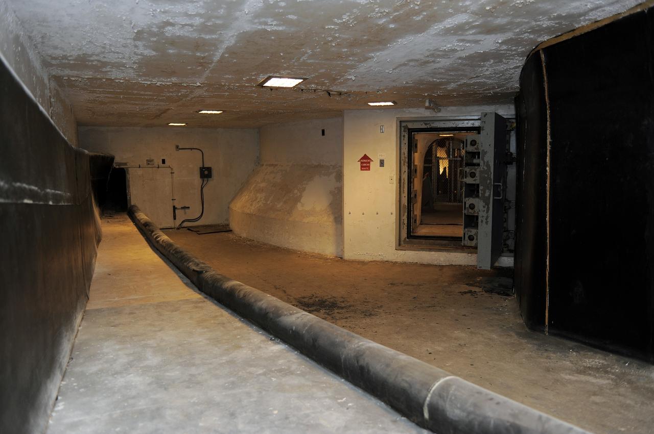 CAPE CANAVERAL, Fla. -- A tunnel beneath Launch Pad 39B at NASA's Kennedy Space Center in Florida leads to the blast-resistant "rubber room." The room is a steel dome floating on rubber isolators and was used as an escape route during the Apollo Program in case of an emergency. It has since been abandoned by astronauts, but throughout the years nature found its way inside, including raccoons, snakes, birds and even a bobcat and opossum.    Starting in 2009, the structure above the room on the pad was no longer needed for NASA's Space Shuttle Program, so it is being restructured for future use. The new design will feature a "clean pad" for rockets to come with their own launcher, making it more versatile for a number of vehicles. For information on NASA's future plans, visit www.nasa.gov. Photo credit: NASA/Kim Shiflett
