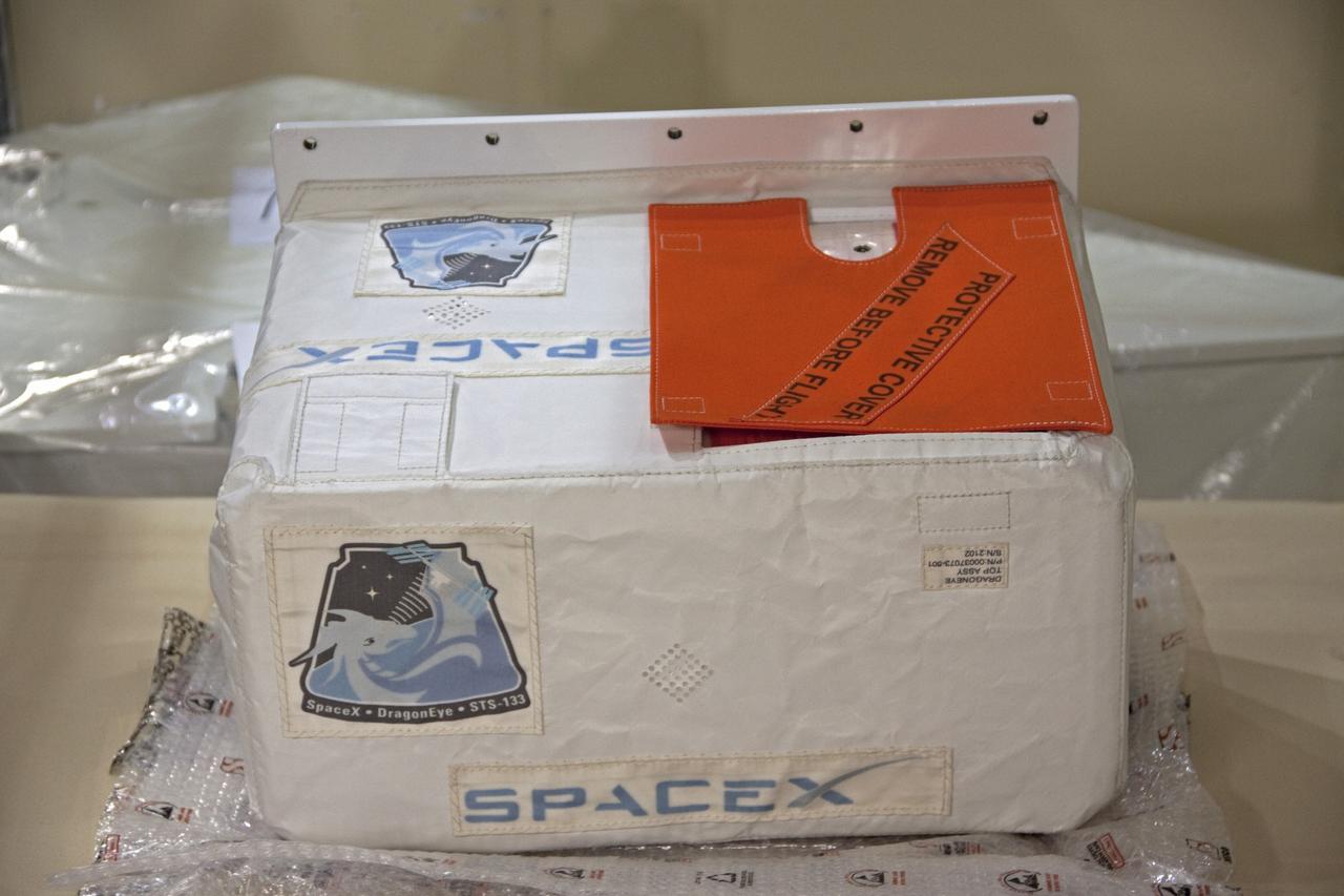 CAPE CANAVERAL, Fla. -- A DragonEye proximity sensor developed by Space Exploration Technologies (SpaceX) is prepared for installation while space shuttle Discovery is in Orbiter Processing Facility-3 at NASA's Kennedy Space Center in Florida. DragonEye is a Laser Imaging Detection and Ranging (LIDAR) sensor that will be tested on Discovery's docking operation with the International Space Station. Discovery's STS-133 mission, targeted to launch Nov. 1, will be the second demonstration of the sensor, following shuttle Endeavour's STS-127 mission in 2009. The DragonEye sensor will guide SpaceX's Dragon spacecraft as it approaches and berths to the station on future cargo re-supply missions. The Dragon spacecraft is a free-flying, reusable spacecraft being developed by SpaceX, which is contracted by NASA's Commercial Orbital Transportation Services (COTS) program. Photo credit: NASA/Jim Grossmann