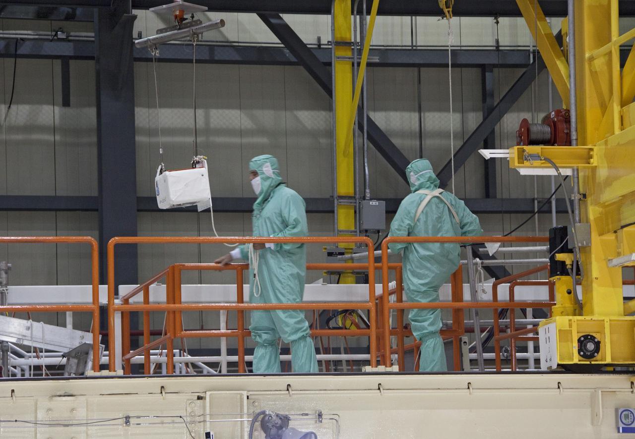 CAPE CANAVERAL, Fla. -- A DragonEye proximity sensor developed by Space Exploration Technologies (SpaceX) is installed while space shuttle Discovery is in Orbiter Processing Facility-3 at NASA's Kennedy Space Center in Florida. DragonEye is a Laser Imaging Detection and Ranging (LIDAR) sensor that will be tested on Discovery's docking operation with the International Space Station. Discovery's STS-133 mission, targeted to launch Nov. 1, will be the second demonstration of the sensor, following shuttle Endeavour's STS-127 mission in 2009. The DragonEye sensor will guide SpaceX's Dragon spacecraft as it approaches and berths to the station on future cargo re-supply missions. The Dragon spacecraft is a free-flying, reusable spacecraft being developed by SpaceX, which is contracted by NASA's Commercial Orbital Transportation Services (COTS) program. Photo credit: NASA/Jim Grossmann