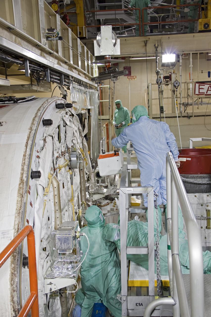 CAPE CANAVERAL, Fla. -- A DragonEye proximity sensor developed by Space Exploration Technologies (SpaceX) is installed while space shuttle Discovery is in Orbiter Processing Facility-3 at NASA's Kennedy Space Center in Florida. DragonEye is a Laser Imaging Detection and Ranging (LIDAR) sensor that will be tested on Discovery's docking operation with the International Space Station. Discovery's STS-133 mission, targeted to launch Nov. 1, will be the second demonstration of the sensor, following shuttle Endeavour's STS-127 mission in 2009. The DragonEye sensor will guide SpaceX's Dragon spacecraft as it approaches and berths to the station on future cargo re-supply missions. The Dragon spacecraft is a free-flying, reusable spacecraft being developed by SpaceX, which is contracted by NASA's Commercial Orbital Transportation Services (COTS) program. Photo credit: NASA/Jim Grossmann