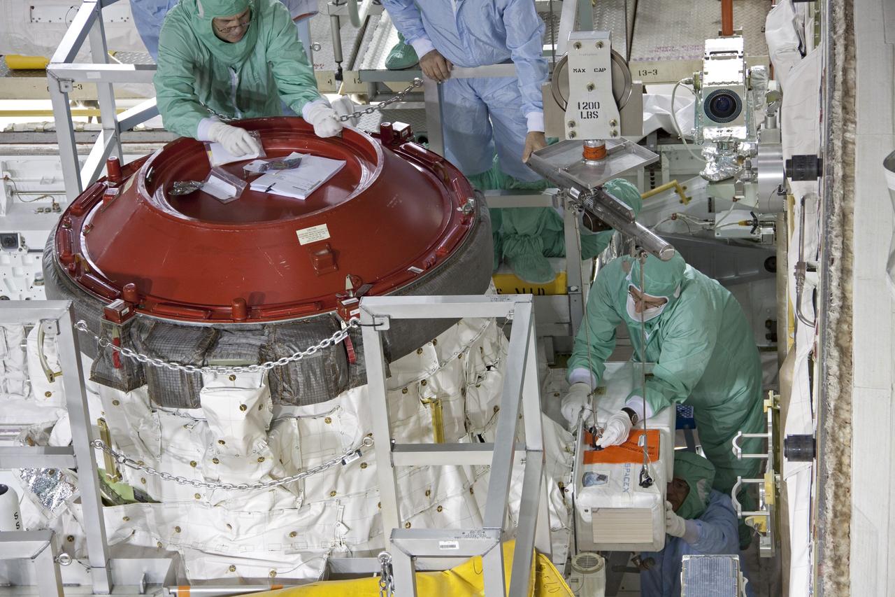 CAPE CANAVERAL, Fla. -- A DragonEye proximity sensor developed by Space Exploration Technologies (SpaceX) is installed while space shuttle Discovery is in Orbiter Processing Facility-3 at NASA's Kennedy Space Center in Florida. DragonEye is a Laser Imaging Detection and Ranging (LIDAR) sensor that will be tested on Discovery's docking operation with the International Space Station. Discovery's STS-133 mission, targeted to launch Nov. 1, will be the second demonstration of the sensor, following shuttle Endeavour's STS-127 mission in 2009. The DragonEye sensor will guide SpaceX's Dragon spacecraft as it approaches and berths to the station on future cargo re-supply missions. The Dragon spacecraft is a free-flying, reusable spacecraft being developed by SpaceX, which is contracted by NASA's Commercial Orbital Transportation Services (COTS) program. Photo credit: NASA/Jim Grossmann