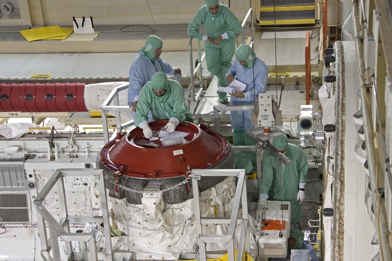 CAPE CANAVERAL, Fla. -- A DragonEye proximity sensor developed by Space Exploration Technologies (SpaceX) is installed while space shuttle Discovery is in Orbiter Processing Facility-3 at NASA's Kennedy Space Center in Florida. DragonEye is a Laser Imaging Detection and Ranging (LIDAR) sensor that will be tested on Discovery's docking operation with the International Space Station. Discovery's STS-133 mission, targeted to launch Nov. 1, will be the second demonstration of the sensor, following shuttle Endeavour's STS-127 mission in 2009. The DragonEye sensor will guide SpaceX's Dragon spacecraft as it approaches and berths to the station on future cargo re-supply missions. The Dragon spacecraft is a free-flying, reusable spacecraft being developed by SpaceX, which is contracted by NASA's Commercial Orbital Transportation Services (COTS) program. Photo credit: NASA/Jim Grossmann