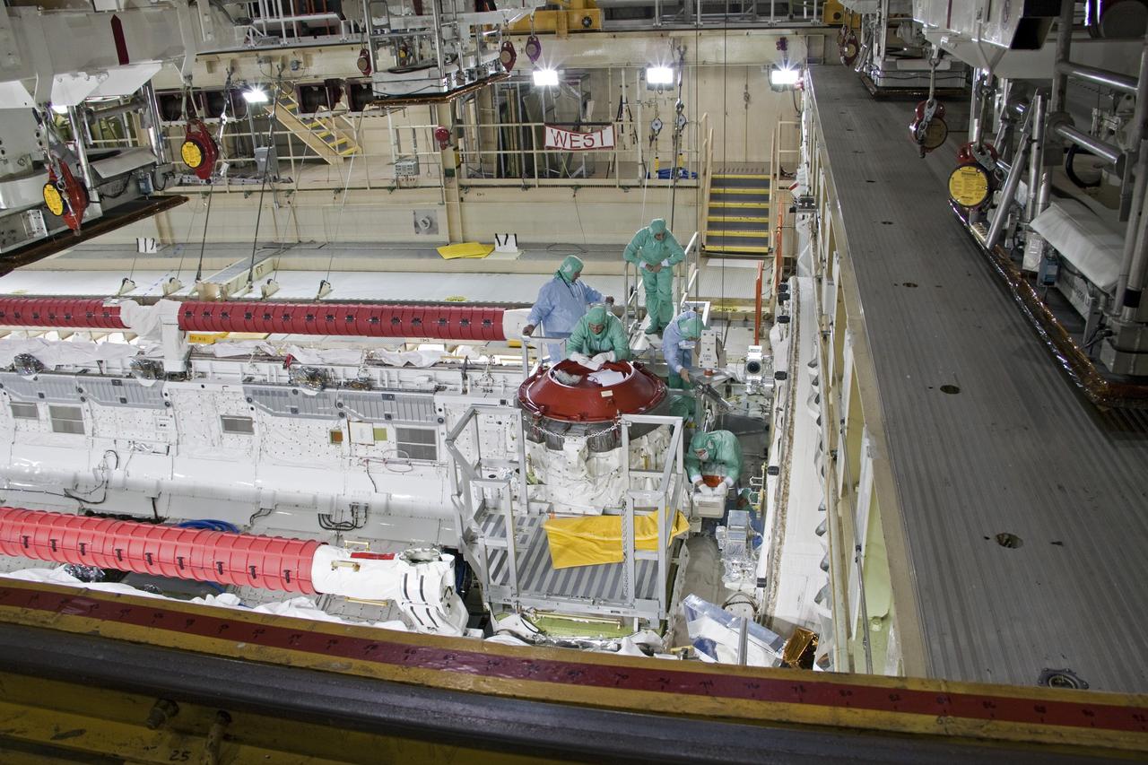 CAPE CANAVERAL, Fla. -- A DragonEye proximity sensor developed by Space Exploration Technologies (SpaceX) is installed while space shuttle Discovery is in Orbiter Processing Facility-3 at NASA's Kennedy Space Center in Florida. DragonEye is a Laser Imaging Detection and Ranging (LIDAR) sensor that will be tested on Discovery's docking operation with the International Space Station. Discovery's STS-133 mission, targeted to launch Nov. 1, will be the second demonstration of the sensor, following shuttle Endeavour's STS-127 mission in 2009. The DragonEye sensor will guide SpaceX's Dragon spacecraft as it approaches and berths to the station on future cargo re-supply missions. The Dragon spacecraft is a free-flying, reusable spacecraft being developed by SpaceX, which is contracted by NASA's Commercial Orbital Transportation Services (COTS) program. Photo credit: NASA/Jim Grossmann