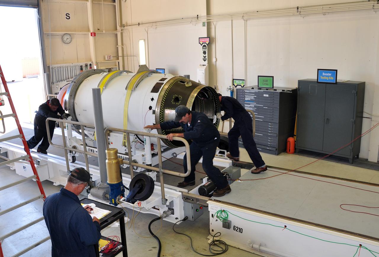VANDENBERG AIR FORCE BASE, Calif. -- At Vandenberg Air Force Base in California, the second stage of the Pegasus XL rocket that will launch the Nuclear Spectroscopic Telescope Array (NuSTAR) to orbit is moved to a stationary rail in Building 1555 for processing. After the rocket and spacecraft are processed at Vandenberg, they will be shipped to the Ronald Reagan Ballistic Missile Defense Test Site located at the Pacific Ocean’s Kwajalein Atoll for launch.    The high-energy X-ray telescope will conduct a census for black holes, map radioactive material in young supernovae remnants, and study the origins of cosmic rays and the extreme physics around collapsed stars.  Photo credit: NASA/Randy Beaudoin, VAFB
