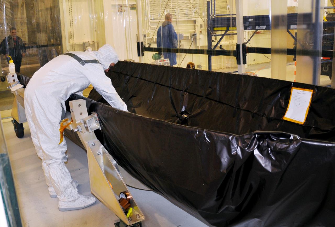 VANDENBERG AIR FORCE BASE, Calif. – At Vandenberg Air Force Base in California, a technician performs a wide-band instrumentation system test on half of the fairing that will encapsulate NASA's Glory satellite during launch aboard a Taurus XL rocket. The black protective covering will be removed so that the fairing half can be thoroughly cleaned before it is installed around the spacecraft. The four-stage rocket and satellite are being prepared for a launch to low Earth orbit from Vandenberg's Space Launch Complex 576-E.    Once Glory reaches orbit, it will collect data on the properties of aerosols and black carbon. It also will help scientists understand how the sun's irradiance affects Earth's climate.  Photo credit: NASA/Randy Beaudoin, VAFB