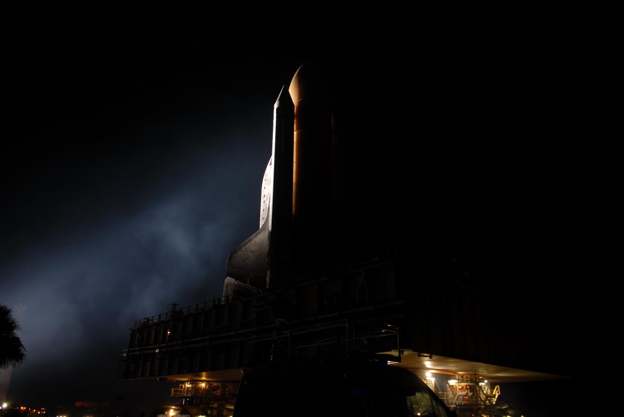 CAPE CANAVERAL, Fla. -- Bathed in bright xenon lights, space shuttle Discovery makes its nighttime trek, known as "rollout," from the Vehicle Assembly Building to Launch Pad 39A at NASA's Kennedy Space Center in Florida. It will take the shuttle, attached to its external fuel tank, twin solid rocket boosters and mobile launcher platform, about six hours to complete the move atop a crawler-transporter. Rollout sets the stage for Discovery's STS-133 crew to practice countdown and launch procedures during the Terminal Countdown Demonstration Test in mid-October. Targeted to liftoff Nov. 1, Discovery will take the Permanent Multipurpose Module (PMM) packed with supplies and critical spare parts, as well as Robonaut 2 (R2) to the International Space Station. Photo credit: NASA/Jim Grossmann