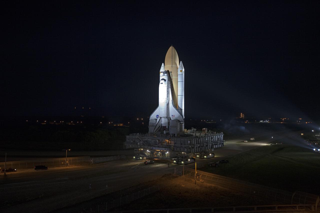 CAPE CANAVERAL, Fla. -- Bathed in bright xenon lights, space shuttle Discovery makes its nighttime trek, known as "rollout," from the Vehicle Assembly Building to Launch Pad 39A at NASA's Kennedy Space Center in Florida. It will take the shuttle, attached to its external fuel tank, twin solid rocket boosters and mobile launcher platform, about six hours to complete the move atop a crawler-transporter. Rollout sets the stage for Discovery's STS-133 crew to practice countdown and launch procedures during the Terminal Countdown Demonstration Test in mid-October. Targeted to liftoff Nov. 1, Discovery will take the Permanent Multipurpose Module (PMM) packed with supplies and critical spare parts, as well as Robonaut 2 (R2) to the International Space Station. Photo credit: NASA/Frankie Martin