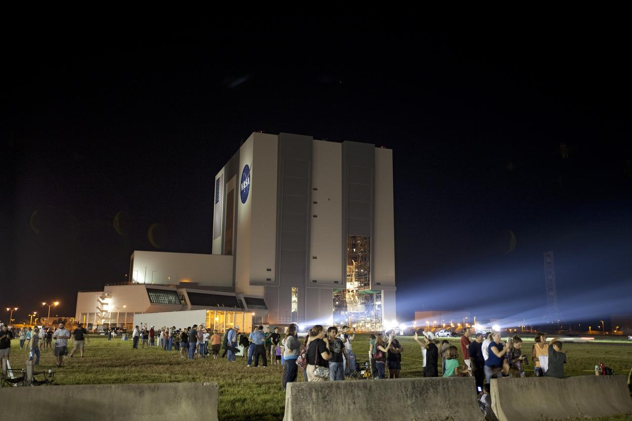 CAPE CANAVERAL, Fla. -- At NASA's Kennedy Space Center in Florida, workers and their friends and families watch as space shuttle Discovery begins its nighttime trek, known as "rollout," from the Vehicle Assembly Building to Launch Pad 39A. It will take the shuttle, attached to its external fuel tank, twin solid rocket boosters and mobile launcher platform, about six hours to complete the move atop a crawler-transporter. Rollout sets the stage for Discovery's STS-133 crew to practice countdown and launch procedures during the Terminal Countdown Demonstration Test in mid-October. Targeted to liftoff Nov. 1, Discovery will take the Permanent Multipurpose Module (PMM) packed with supplies and critical spare parts, as well as Robonaut 2 (R2) to the International Space Station. Photo credit: NASA/Frankie Martin