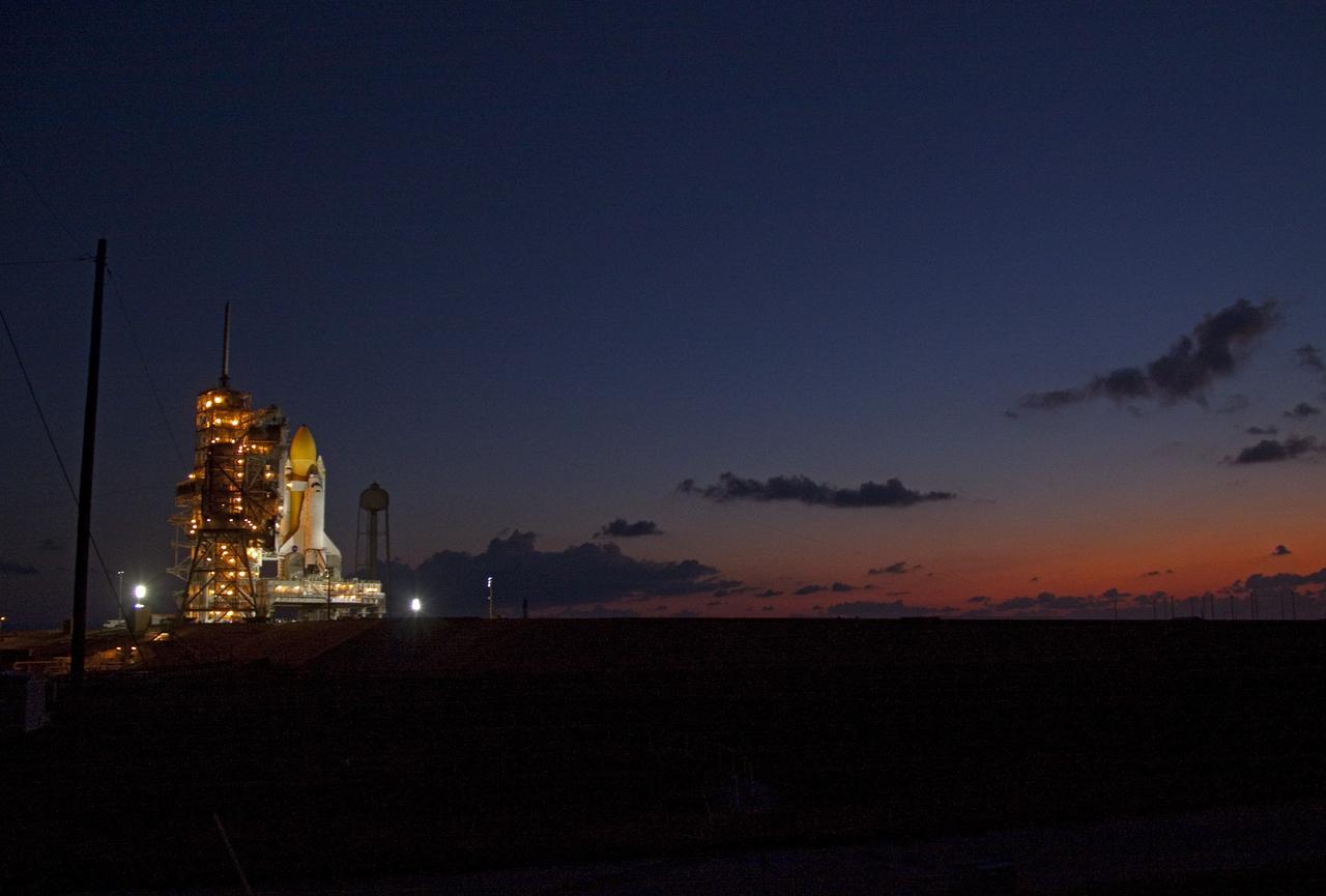 CAPE CANAVERAL, Fla. -- Space shuttle Discovery is attached to Launch Pad 39A as the sun rises over NASA's Kennedy Space Center in Florida. It took the spacecraft about six hours to make the journey, known as "rollout," from the Vehicle Assembly Building to the pad. Rollout sets the stage for Discovery's STS-133 crew to practice countdown and launch procedures during the Terminal Countdown Demonstration Test in mid-October. Targeted to liftoff Nov. 1, Discovery will take the Permanent Multipurpose Module (PMM) packed with supplies and critical spare parts, as well as Robonaut 2 (R2) to the International Space Station. Photo credit: NASA/Jack Pfaller