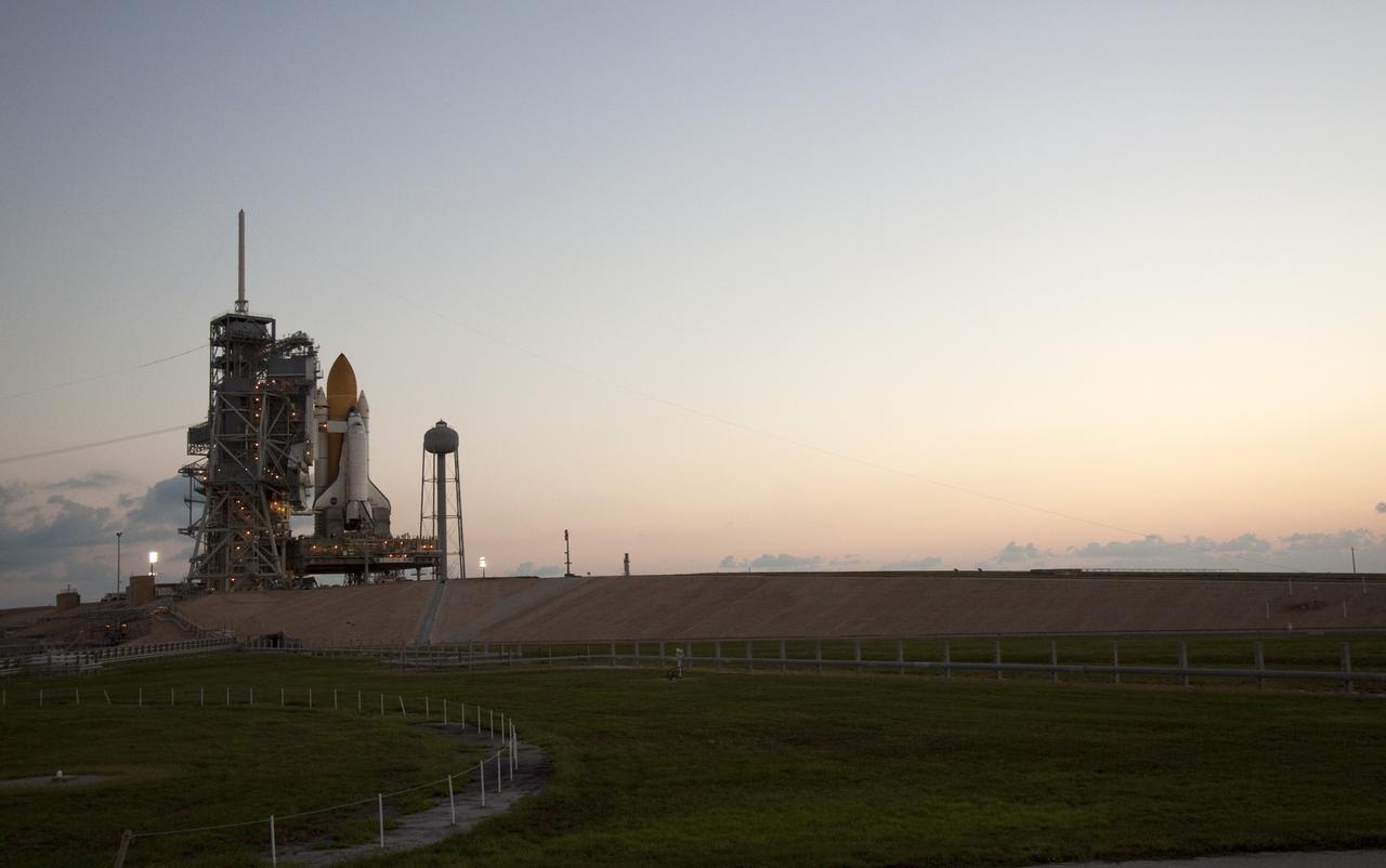 CAPE CANAVERAL, Fla. -- Space shuttle Discovery is attached to Launch Pad 39A as the sun rises over NASA's Kennedy Space Center in Florida. It took the spacecraft about six hours to make the journey, known as "rollout," from the Vehicle Assembly Building to the pad. Rollout sets the stage for Discovery's STS-133 crew to practice countdown and launch procedures during the Terminal Countdown Demonstration Test in mid-October. Targeted to liftoff Nov. 1, Discovery will take the Permanent Multipurpose Module (PMM) packed with supplies and critical spare parts, as well as Robonaut 2 (R2) to the International Space Station. Photo credit: NASA/Jack Pfaller