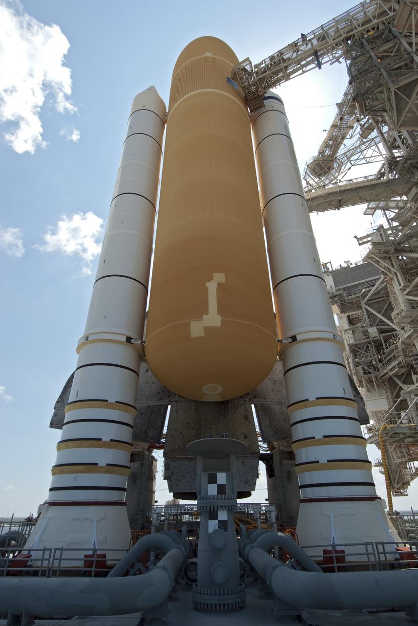 CAPE CANAVERAL, Fla. -- At NASA's Kennedy Space Center in Florida, space shuttle Discovery's external fuel tank and solid rocket boosters are visible on Launch Pad 39A before the rotating service structure, which protects the shuttle from the elements and provides access to the shuttle, is moved into place. It took the spacecraft about six hours to make the journey, known as "rollout," from the Vehicle Assembly Building to the pad. Rollout sets the stage for Discovery's STS-133 crew to practice countdown and launch procedures during the Terminal Countdown Demonstration Test in mid-October. Targeted to liftoff Nov. 1, Discovery will take the Permanent Multipurpose Module (PMM) packed with supplies and critical spare parts, as well as Robonaut 2 (R2) to the International Space Station. Photo credit: NASA/Jim Grossmann