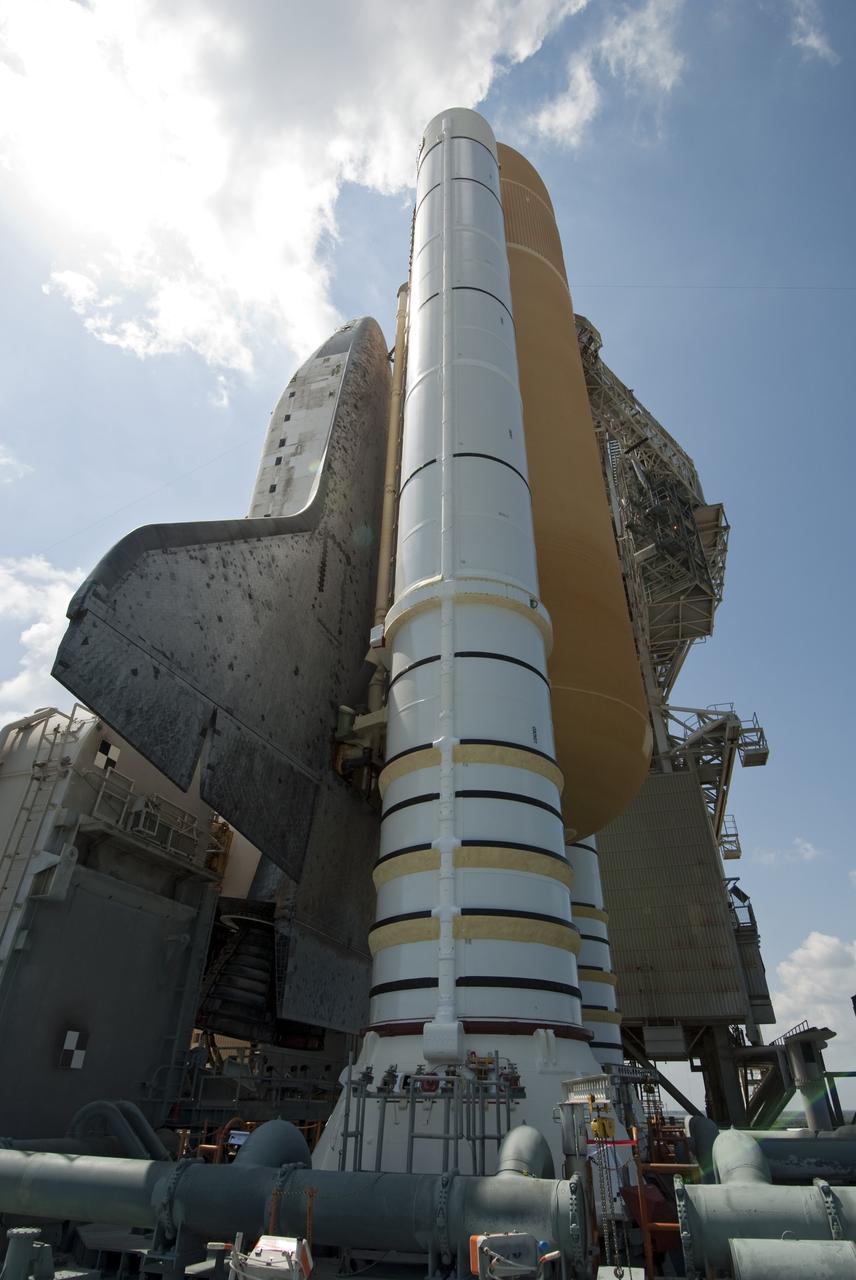 CAPE CANAVERAL, Fla. -- At NASA's Kennedy Space Center in Florida, space shuttle Discovery is visible on Launch Pad 39A before the rotating service structure, which protects it from the elements and provides access to the shuttle, is moved into place. It took the spacecraft about six hours to make the journey, known as "rollout," from the Vehicle Assembly Building to the pad. Rollout sets the stage for Discovery's STS-133 crew to practice countdown and launch procedures during the Terminal Countdown Demonstration Test in mid-October. Targeted to liftoff Nov. 1, Discovery will take the Permanent Multipurpose Module (PMM) packed with supplies and critical spare parts, as well as Robonaut 2 (R2) to the International Space Station. Photo credit: NASA/Jim Grossmann