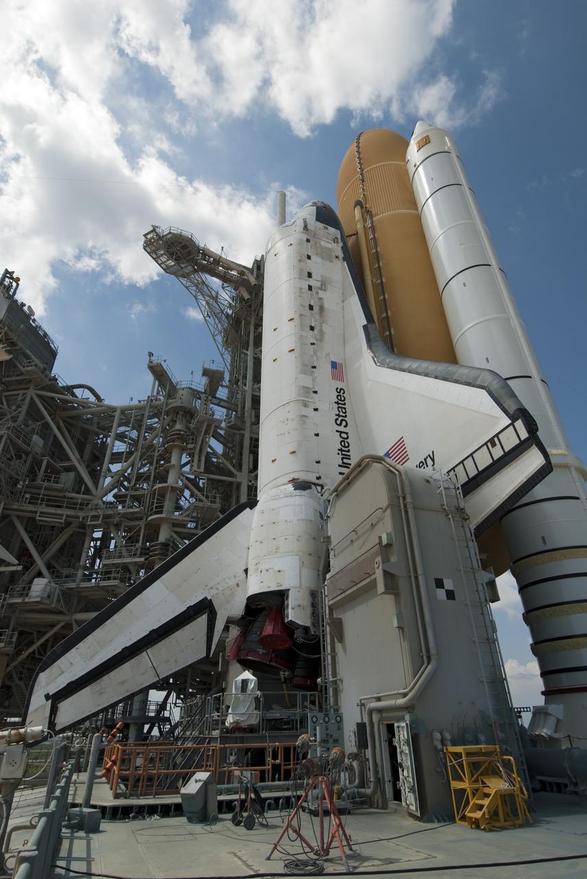 CAPE CANAVERAL, Fla. -- At NASA's Kennedy Space Center in Florida, space shuttle Discovery is visible on Launch Pad 39A before the rotating service structure, which protects it from the elements and provides access to the shuttle, is moved into place. It took the spacecraft about six hours to make the journey, known as "rollout," from the Vehicle Assembly Building to the pad. Rollout sets the stage for Discovery's STS-133 crew to practice countdown and launch procedures during the Terminal Countdown Demonstration Test in mid-October. Targeted to liftoff Nov. 1, Discovery will take the Permanent Multipurpose Module (PMM) packed with supplies and critical spare parts, as well as Robonaut 2 (R2) to the International Space Station. Photo credit: NASA/Jim Grossmann
