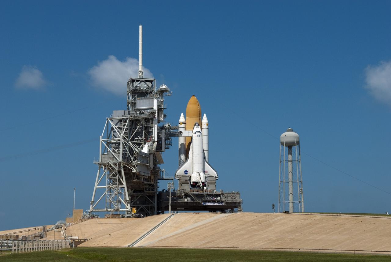 CAPE CANAVERAL, Fla. -- At NASA's Kennedy Space Center in Florida, space shuttle Discovery is visible on Launch Pad 39A before the rotating service structure, which protects it from the elements and provides access to the shuttle, is moved into place. It took the spacecraft about six hours to make the journey, known as "rollout," from the Vehicle Assembly Building to the pad. Rollout sets the stage for Discovery's STS-133 crew to practice countdown and launch procedures during the Terminal Countdown Demonstration Test in mid-October. Targeted to liftoff Nov. 1, Discovery will take the Permanent Multipurpose Module (PMM) packed with supplies and critical spare parts, as well as Robonaut 2 (R2) to the International Space Station. Photo credit: NASA/Jim Grossmann