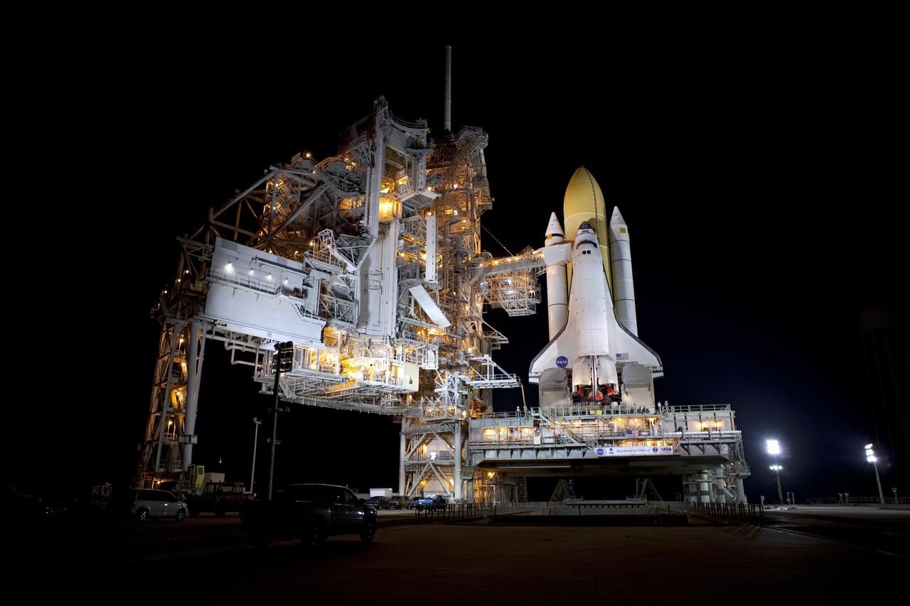 CAPE CANAVERAL, Fla. -- Space shuttle Discovery stands tall on Launch Pad 39A at NASA's Kennedy Space Center in Florida as space center workers prepare to move the rotating service structure into place. The structure protects the shuttle from the elements and allows access into the spacecraft while on the pad. Targeted to liftoff Nov. 1, Discovery will take the Permanent Multipurpose Module (PMM) packed with supplies and critical spare parts, as well as Robonaut 2 (R2) to the International Space Station on the STS-133 mission. Photo credit: NASA/Dimitri Gerondidakis