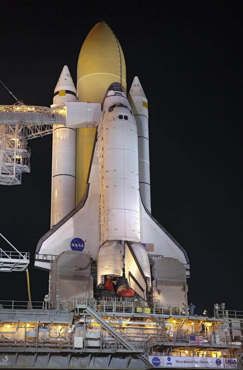 CAPE CANAVERAL, Fla. -- Space shuttle Discovery stands tall on Launch Pad 39A at NASA's Kennedy Space Center in Florida as space center workers prepare to move the rotating service structure into place. The structure protects the shuttle from the elements and allows access into the spacecraft while on the pad. Targeted to liftoff Nov. 1, Discovery will take the Permanent Multipurpose Module (PMM) packed with supplies and critical spare parts, as well as Robonaut 2 (R2) to the International Space Station on the STS-133 mission. Photo credit: NASA/Dimitri Gerondidakis