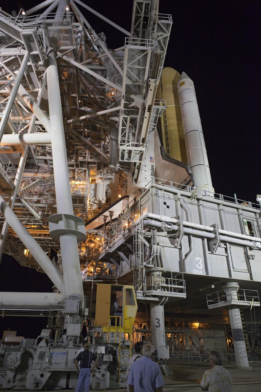 CAPE CANAVERAL, Fla. -- Workers at NASA's Kennedy Space Center in Florida move the rotating service structure into place around space shuttle Discovery on Launch Pad 39A. The structure protects the shuttle from the elements and allows access into the spacecraft while on the pad. Targeted to liftoff Nov. 1, Discovery will take the Permanent Multipurpose Module (PMM) packed with supplies and critical spare parts, as well as Robonaut 2 (R2) to the International Space Station on the STS-133 mission. Photo credit: NASA/Dimitri Gerondidakis