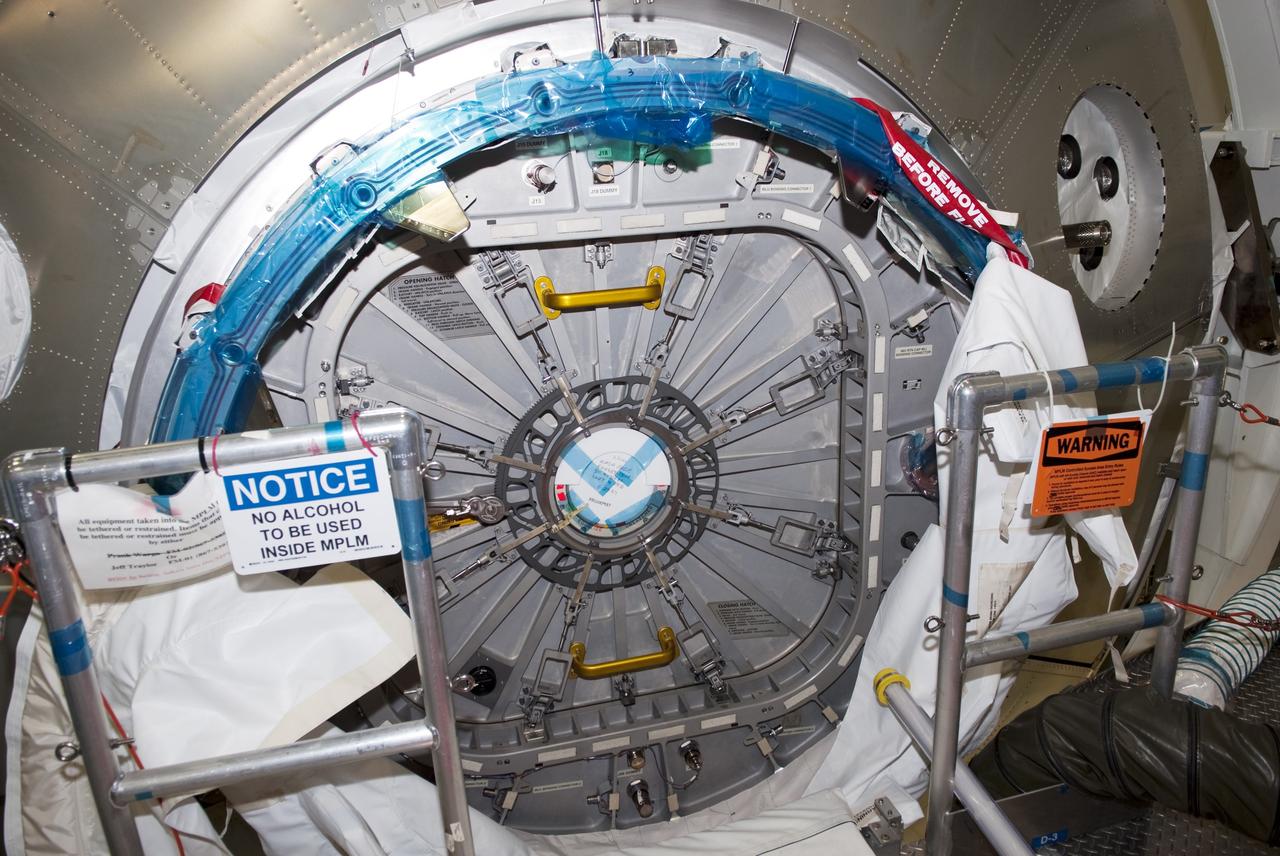 CAPE CANAVERAL, Fla. -- Inside the Space Station Processing Facility at NASA's Kennedy Space Center in Florida, the hatch of the Permanent Multipurpose Module (PMM) is closed in preparation for space shuttle Discovery's STS-133 mission to the International Space Station. Robonaut 2 (R2) and critical spare parts are packed inside the PMM, which will be left aboard the station on Discovery's final mission. Targeted to launch Nov. 1 at 4:40 p.m. EDT, Discovery and its crew also will carry Express Logistics Carrier-4 (ELC-4), which is filled with external payloads and experiments. For more information visit, www.nasa.gov/shuttle. Photo credit: NASA/Jim Grossmann