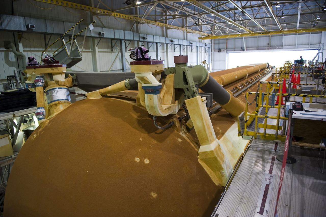 NEW ORLEANS -- Workers at NASA's Michoud Assembly Facility in New Orleans prepare the Space Shuttle Program's last external fuel tank, ET-122, for transportation to NASA's Kennedy Space Center in Florida. The tank will travel 900 miles by sea secured aboard the Pegasus Barge, offloaded and moved to Kennedy's Vehicle Assembly Building where it will be integrated to space shuttle Endeavour for the STS-134 mission to the International Space Station.        The tank, which is the largest element of the space shuttle stack, was damaged during Hurricane Katrina in August 2005 and restored to flight configuration by Lockheed Martin Space Systems Company employees. STS-134, targeted to launch Feb. 2011, currently is scheduled to be the last mission in the Space Shuttle Program. Photo credit: NASA/Kim Shiflett