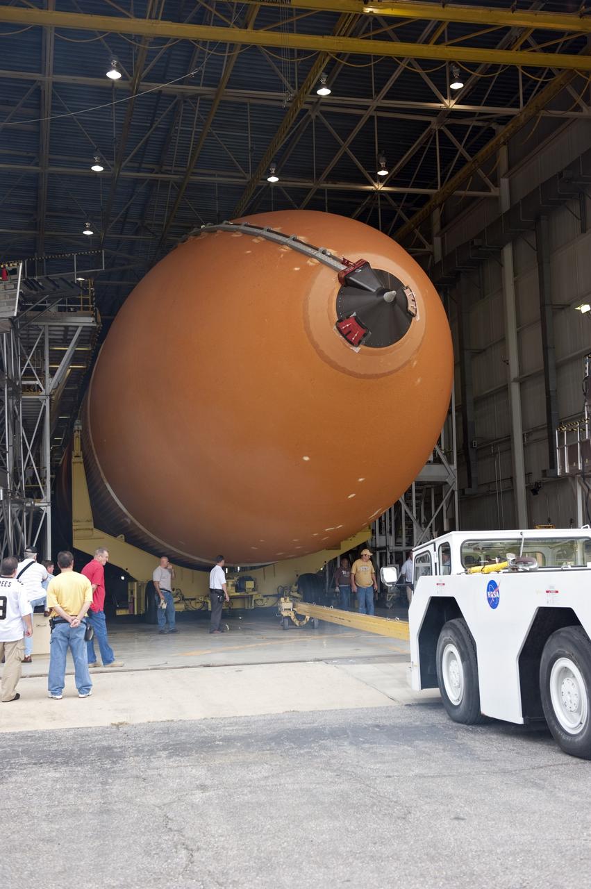 NEW ORLEANS -- Workers escort the Space Shuttle Program's last external fuel tank, ET-122, from NASA's Michoud Assembly Facility in New Orleans for transportation to NASA's Kennedy Space Center in Florida. The tank will travel 900 miles by sea secured aboard the Pegasus Barge, offloaded and moved to Kennedy's Vehicle Assembly Building where it will be integrated to space shuttle Endeavour for the STS-134 mission to the International Space Station.    The tank, which is the largest element of the space shuttle stack, was damaged during Hurricane Katrina in August 2005 and restored to flight configuration by Lockheed Martin Space Systems Company employees. STS-134, targeted to launch Feb. 2011, currently is scheduled to be the last mission in the Space Shuttle Program. Photo credit: NASA/Kim Shiflett