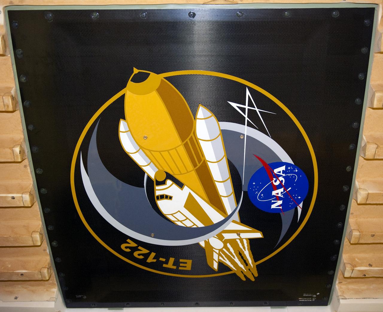 NEW ORLEANS -- To commemorate the history of the Space Shuttle Program's last external fuel tank, its intertank door is emblazoned with an ET-122 insignia. The external tank will travel 900 miles by sea from NASA's Michoud Assembly Facility in New Orleans to NASA's Kennedy Space Center in Florida secured aboard the Pegasus Barge, offloaded and moved to Kennedy's Vehicle Assembly Building where it will be integrated to space shuttle Endeavour for the STS-134 mission to the International Space Station.      The tank, which is the largest element of the space shuttle stack, was damaged during Hurricane Katrina in August 2005 and restored to flight configuration by Lockheed Martin Space Systems Company employees. STS-134, targeted to launch Feb. 2011, currently is scheduled to be the last mission in the Space Shuttle Program. Photo credit: NASA/Kim Shiflett