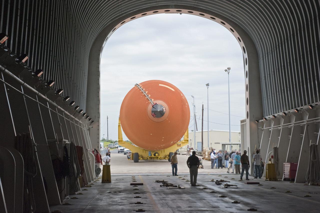 NEW ORLEANS -- Workers monitor the progress of the Space Shuttle Program's last external fuel tank, ET-122, from NASA's Michoud Assembly Facility in New Orleans as it is being loaded onto the Pegasus Barge. The tank will travel 900 miles by sea to NASA's Kennedy Space Center in Florida secured aboard the barge, offloaded and moved to Kennedy's Vehicle Assembly Building where it will be integrated to space shuttle Endeavour for the STS-134 mission to the International Space Station.      The tank, which is the largest element of the space shuttle stack, was damaged during Hurricane Katrina in August 2005 and restored to flight configuration by Lockheed Martin Space Systems Company employees. STS-134, targeted to launch Feb. 2011, currently is scheduled to be the last mission in the Space Shuttle Program. Photo credit: NASA/Kim Shiflett