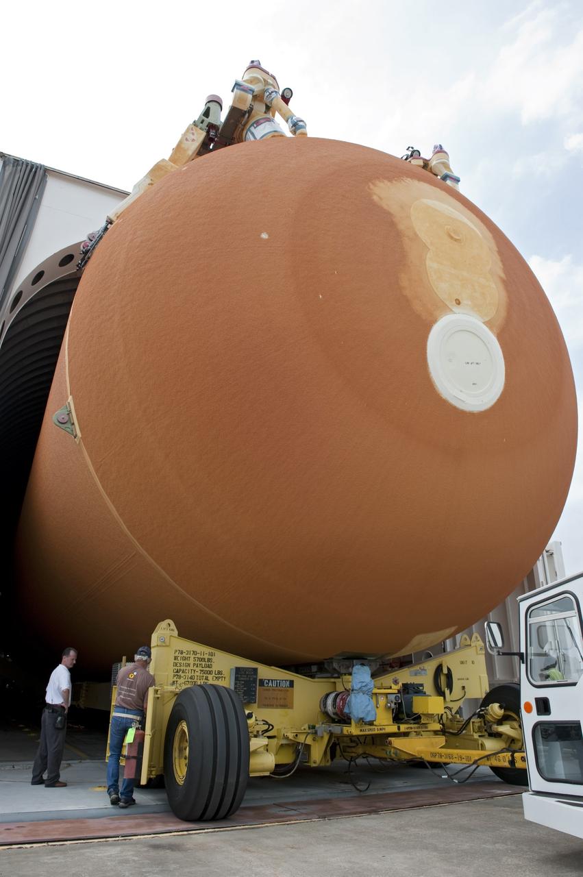 NEW ORLEANS -- Workers watch the progress of the Space Shuttle Program's last external fuel tank, ET-122, at NASA's Michoud Assembly Facility in New Orleans, as it is being loaded onto the Pegasus Barge. The tank will travel 900 miles by sea to NASA's Kennedy Space Center in Florida secured aboard the barge, offloaded and moved to Kennedy's Vehicle Assembly Building where it will be integrated to space shuttle Endeavour for the STS-134 mission to the International Space Station.      The tank, which is the largest element of the space shuttle stack, was damaged during Hurricane Katrina in August 2005 and restored to flight configuration by Lockheed Martin Space Systems Company employees. STS-134, targeted to launch Feb. 2011, currently is scheduled to be the last mission in the Space Shuttle Program. Photo credit: NASA/Kim Shiflett