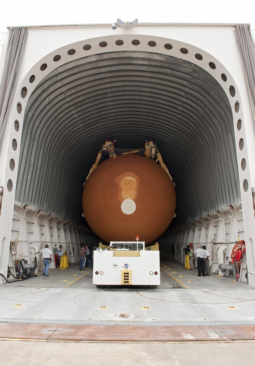 NEW ORLEANS -- Workers check the progress of the Space Shuttle Program's last external fuel tank, ET-122, at NASA's Michoud Assembly Facility in New Orleans as it is being loaded onto the Pegasus Barge. The tank will travel 900 miles by sea to NASA's Kennedy Space Center in Florida secured aboard the barge, offloaded and moved to Kennedy's Vehicle Assembly Building where it will be integrated to space shuttle Endeavour for the STS-134 mission to the International Space Station      The tank, which is the largest element of the space shuttle stack, was damaged during Hurricane Katrina in August 2005 and restored to flight configuration by Lockheed Martin Space Systems Company employees. STS-134, targeted to launch Feb. 2011, currently is scheduled to be the last mission in the Space Shuttle Program. Photo credit: NASA/Kim Shiflett