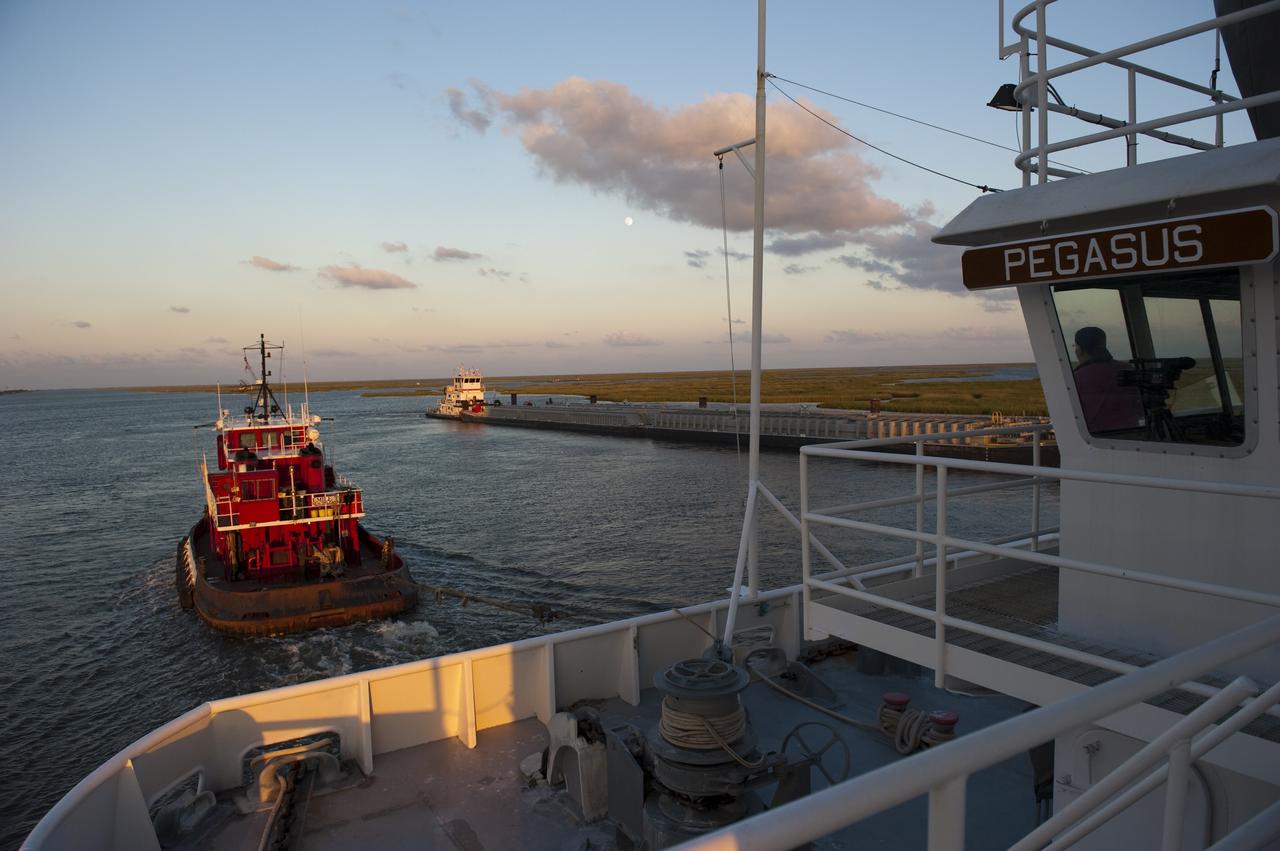 NEW ORLEANS -- A tug boat is pulls the Pegasus Barge carrying the Space Shuttle Program's last external fuel tank, ET-122, from NASA's Michoud Assembly Facility in New Orleans to NASA's Kennedy Space Center in Florida. The tank will travel 900 miles by sea before being offloaded and moved to Kennedy's Vehicle Assembly Building. There it will be integrated to space shuttle Endeavour for the STS-134 mission to the International Space Station. The tank, which is the largest element of the space shuttle stack, was damaged during Hurricane Katrina in August 2005 and restored to flight configuration by Lockheed Martin Space Systems Company employees. STS-134, targeted to launch Feb. 2011, currently is scheduled to be the last mission in the Space Shuttle Program. Photo credit: NASA/Kim Shiflett