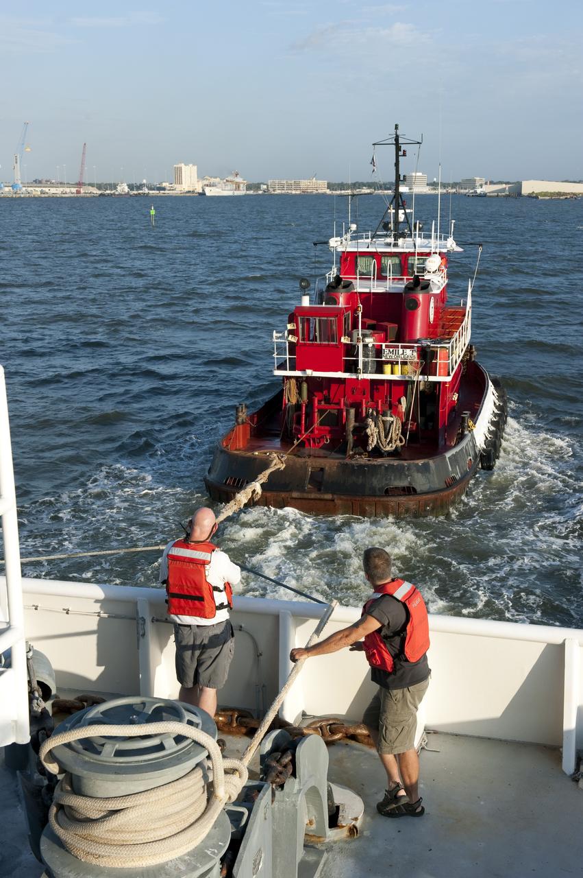 LOUISIANA -- A tug boat pulls the Pegasus Barge carrying the Space Shuttle Program's last external fuel tank, ET-122, from NASA's Michoud Assembly Facility in New Orleans toward a dock in Gulfport, La. The barge will meet up with Freedom Star, NASA's solid rocket booster retrieval ship, which will escort it to NASA's Kennedy Space Center in Florida. The tank will travel 900 miles by sea before being offloaded and moved to Kennedy's Vehicle Assembly Building. There it will be integrated to space shuttle Endeavour for the STS-134 mission to the International Space Station.            The tank, which is the largest element of the space shuttle stack, was damaged during Hurricane Katrina in August 2005 and restored to flight configuration by Lockheed Martin Space Systems Company employees. STS-134, targeted to launch Feb. 2011, currently is scheduled to be the last mission in the Space Shuttle Program. Photo credit: NASA/Kim Shiflett