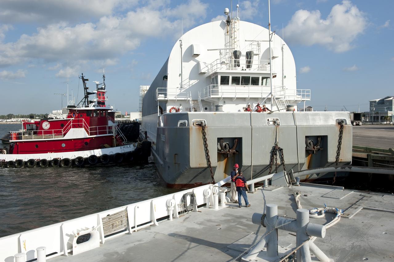 LOUISIANA -- In Gulfport, La., workers connect the Pegasus Barge carrying the Space Shuttle Program's last external fuel tank, ET-122, to Freedom Star, NASA's solid rocket booster retrieval ship. The tank will travel 900 miles by sea to NASA's Kennedy Space Center in Florida before being offloaded and moved to Kennedy's Vehicle Assembly Building. There it will be integrated to space shuttle Endeavour for the STS-134 mission to the International Space Station.            The tank, which is the largest element of the space shuttle stack, was damaged during Hurricane Katrina in August 2005 and restored to flight configuration by Lockheed Martin Space Systems Company employees. STS-134, targeted to launch Feb. 2011, currently is scheduled to be the last mission in the Space Shuttle Program. Photo credit: NASA/Kim Shiflett