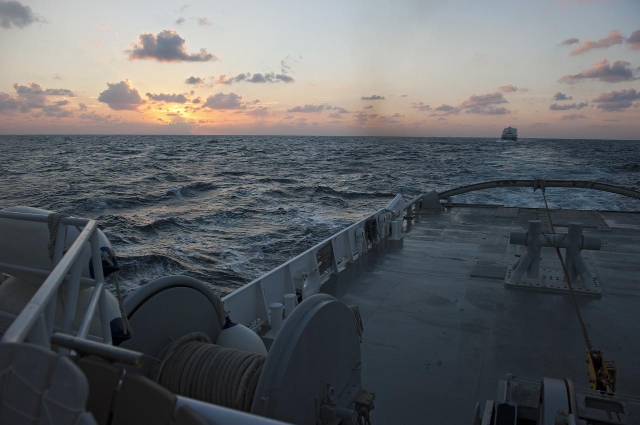 CAPE CANAVERAL, Fla. -- This view at dusk from the stern of Freedom Star, one of NASA's solid rocket booster retrieval ships, shows the Pegasus Barge carrying the Space Shuttle Program's last external fuel tank, ET-122, as it is transported to NASA's Kennedy Space Center in Florida. The tank will travel 900 miles by sea before being offloaded and moved to Kennedy's Vehicle Assembly Building where it will be integrated to space shuttle Endeavour for the STS-134 mission to the International Space Station.            The tank, which is the largest element of the space shuttle stack, was damaged during Hurricane Katrina in August 2005 and restored to flight configuration by Lockheed Martin Space Systems Company employees. STS-134, targeted to launch Feb. 2011, currently is scheduled to be the last mission in the Space Shuttle Program. Photo credit: NASA/Kim Shiflett