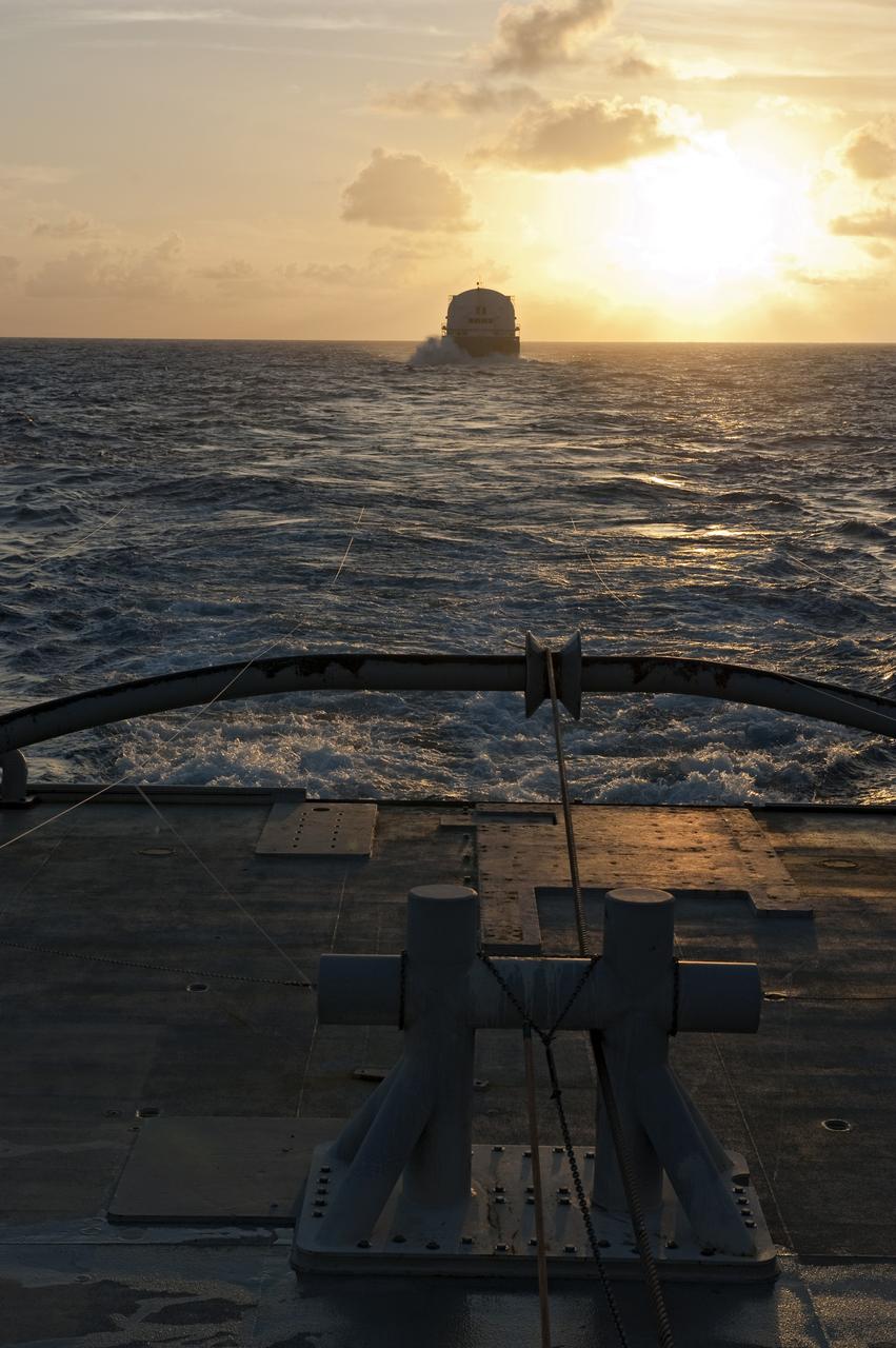 CAPE CANAVERAL, Fla. -- This sunrise view from the stern of Freedom Star, one of NASA's solid rocket booster retrieval ships, shows the Pegasus Barge carrying the Space Shuttle Program's last external fuel tank, ET-122. The tank will travel 900 miles by sea to NASA's Kennedy Space Center in Florida before being offloaded and moved to Kennedy's Vehicle Assembly Building. There it will be integrated to space shuttle Endeavour for the STS-134 mission to the International Space Station.        The tank, which is the largest element of the space shuttle stack, was damaged during Hurricane Katrina in August 2005 and restored to flight configuration by Lockheed Martin Space Systems Company employees. STS-134, targeted to launch Feb. 2011, currently is scheduled to be the last mission in the Space Shuttle Program. Photo credit: NASA/Kim Shiflett