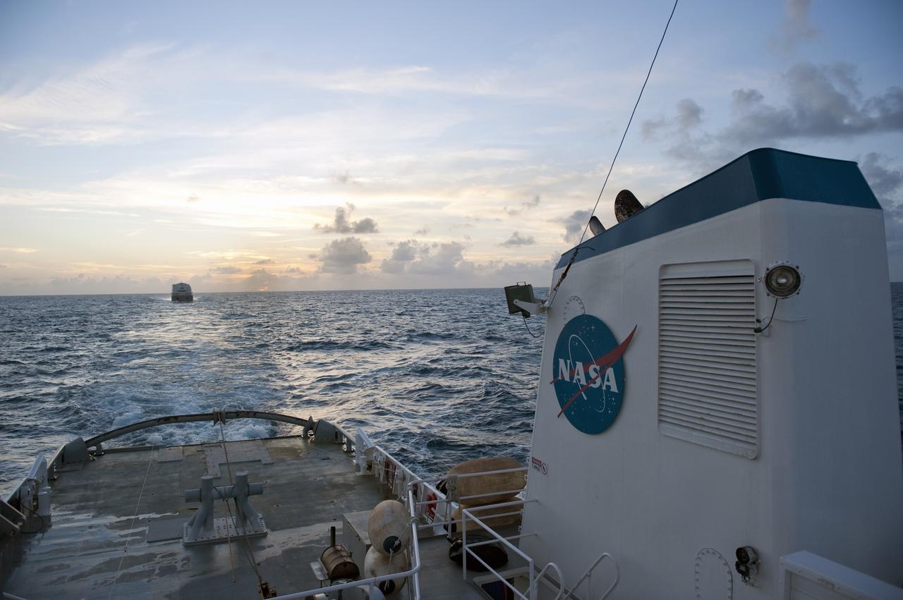 CAPE CANAVERAL, Fla. -- This view from the stern of Freedom Star, one of NASA's solid rocket booster retrieval ships, shows the Pegasus Barge carrying the Space Shuttle Program's last external fuel tank, ET-122. The tank will travel 900 miles by sea to NASA's Kennedy Space Center in Florida before being offloaded and moved to Kennedy's Vehicle Assembly Building. There it will be integrated to space shuttle Endeavour for the STS-134 mission to the International Space Station.        The tank, which is the largest element of the space shuttle stack, was damaged during Hurricane Katrina in August 2005 and restored to flight configuration by Lockheed Martin Space Systems Company employees. STS-134, targeted to launch Feb. 2011, currently is scheduled to be the last mission in the Space Shuttle Program. Photo credit: NASA/Kim Shiflett