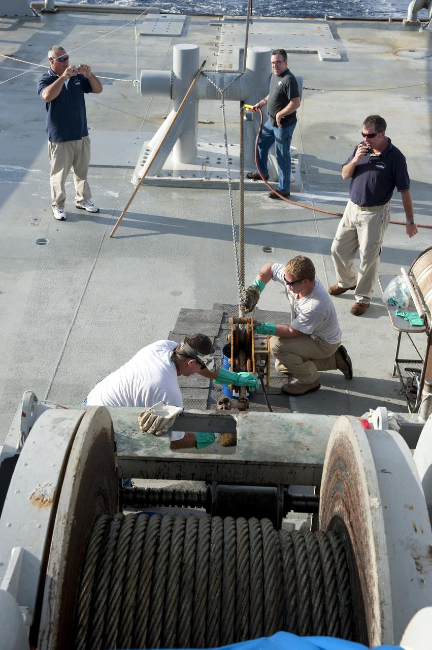 CAPE CANAVERAL, Fla. -- Deckhands on Freedom Star, one of NASA's solid rocket booster retrieval ships, keep the ship in good repair as it pulls the Pegasus Barge carrying the Space Shuttle Program's last external fuel tank, ET-122. The tank will travel 900 miles by sea to NASA's Kennedy Space Center in Florida before being offloaded and moved to Kennedy's Vehicle Assembly Building. There it will be integrated to space shuttle Endeavour for the STS-134 mission to the International Space Station.        The tank, which is the largest element of the space shuttle stack, was damaged during Hurricane Katrina in August 2005 and restored to flight configuration by Lockheed Martin Space Systems Company employees. STS-134, targeted to launch Feb. 2011, currently is scheduled to be the last mission in the Space Shuttle Program. Photo credit: NASA/Kim Shiflett