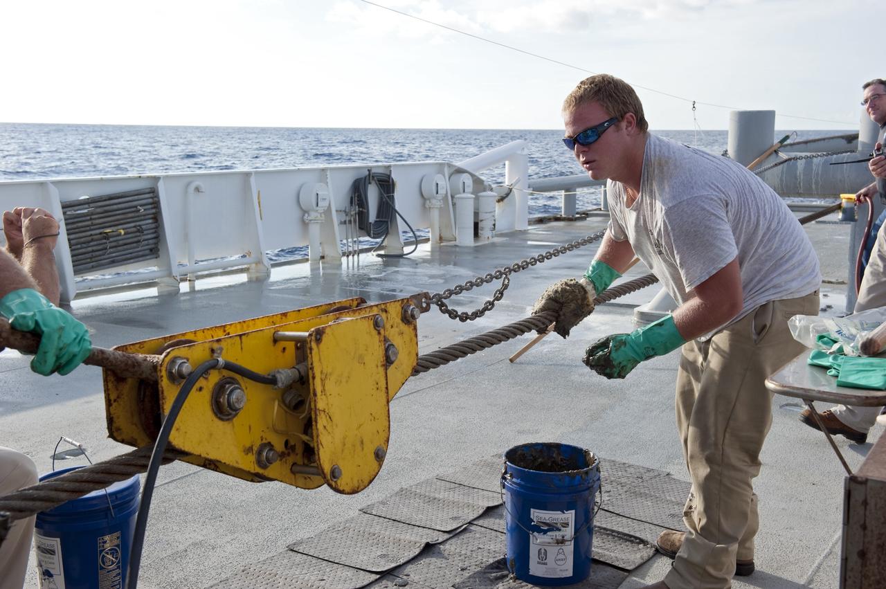 CAPE CANAVERAL, Fla. -- Deckhands on Freedom Star, one of NASA's solid rocket booster retrieval ships, keep the ship in good repair as it pulls the Pegasus Barge carrying the Space Shuttle Program's last external fuel tank, ET-122. The tank will travel 900 miles by sea to NASA's Kennedy Space Center in Florida before being offloaded and moved to Kennedy's Vehicle Assembly Building. There it will be integrated to space shuttle Endeavour for the STS-134 mission to the International Space Station.        The tank, which is the largest element of the space shuttle stack, was damaged during Hurricane Katrina in August 2005 and restored to flight configuration by Lockheed Martin Space Systems Company employees. STS-134, targeted to launch Feb. 2011, currently is scheduled to be the last mission in the Space Shuttle Program. Photo credit: NASA/Kim Shiflett