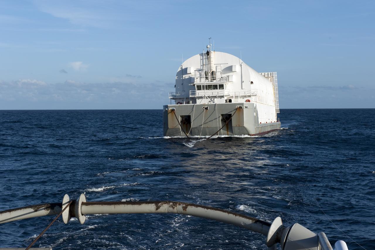 CAPE CANAVERAL, Fla. -- This view from the stern of Freedom Star, one of NASA's solid rocket booster retrieval ships, shows the Pegasus Barge carrying the Space Shuttle Program's last external fuel tank, ET-122. The tank will travel 900 miles by sea to NASA's Kennedy Space Center in Florida before being offloaded and moved to Kennedy's Vehicle Assembly Building. There it will be integrated to space shuttle Endeavour for the STS-134 mission to the International Space Station.        The tank, which is the largest element of the space shuttle stack, was damaged during Hurricane Katrina in August 2005 and restored to flight configuration by Lockheed Martin Space Systems Company employees. STS-134, targeted to launch Feb. 2011, currently is scheduled to be the last mission in the Space Shuttle Program. Photo credit: NASA/Kim Shiflett
