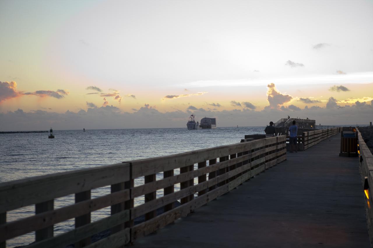 CAPE CANAVERAL, Fla. -- Freedom Star, one of NASA's solid rocket booster retrieval ships, pulls the Space Shuttle Program's last external fuel tank, ET-122, toward NASA's Kennedy Space Center in Florida. The tank traveled 900 miles by sea from NASA's Michoud Assembly Facility in New Orleans aboard the Pegasus Barge. After reaching the Turn Basin at Kennedy, the tank will be offloaded and moved to the Vehicle Assembly Building where it eventually will be attached to space shuttle Endeavour for the STS-134 mission to the International Space Station. STS-134, targeted to launch in Feb. 2011, currently is scheduled to be the last mission in the Space Shuttle Program.        The tank, which is the largest element of the space shuttle stack, was damaged during Hurricane Katrina in August 2005 and restored to flight configuration by Lockheed Martin Space Systems Company employees. Photo credit: NASA/Frankie Martin